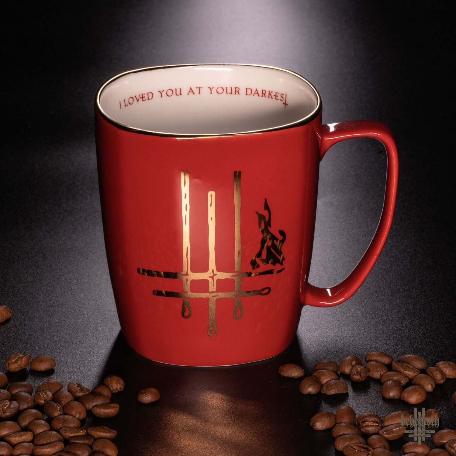 Red Behemoth mug with gold Trivmviratvs print and 'I Loved You At Your Darkest' text inside, surrounded by coffee beans.