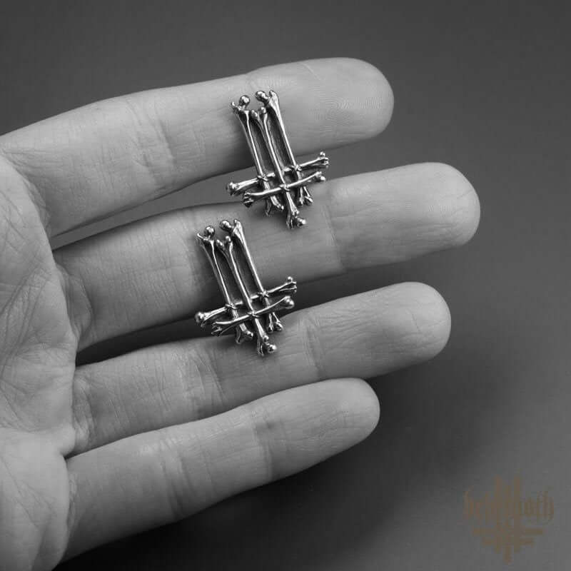 Hand holding Behemoth 'Trivmviratvs' sterling silver cufflinks with dark, edgy design, crafted by Anna Mazon Jewellery.