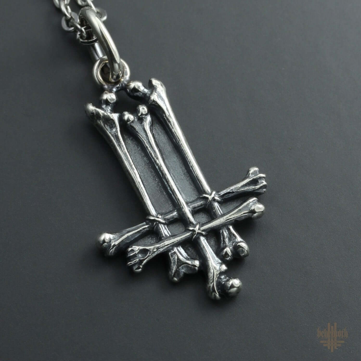 Behemoth 'Trivmviratvs - Bones' sterling silver necklace with detailed bone-shaped pendant on a stainless steel chain.