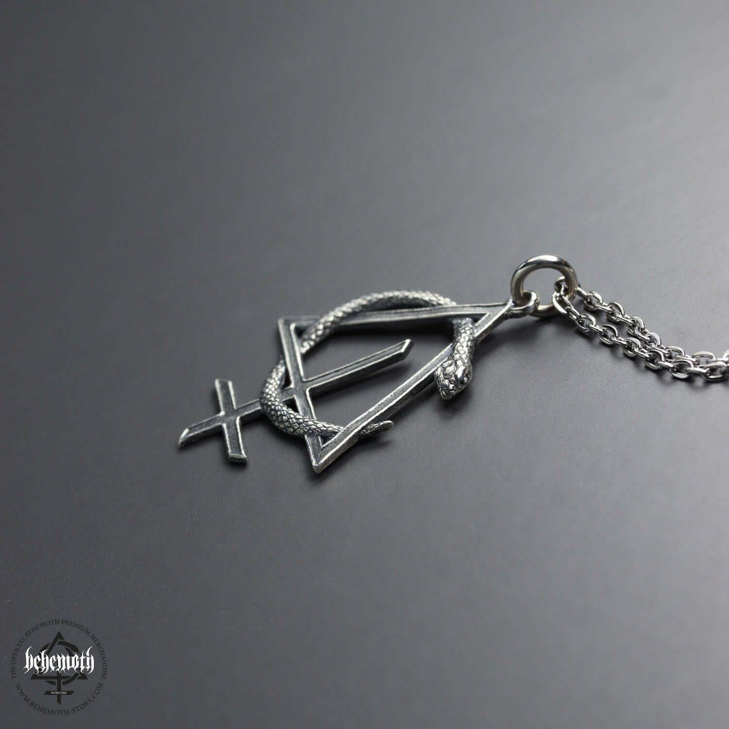 Behemoth 'CONTRA' sterling silver necklace, showcasing dark openwork pendant, crafted with the lost wax technique, on a grey background.