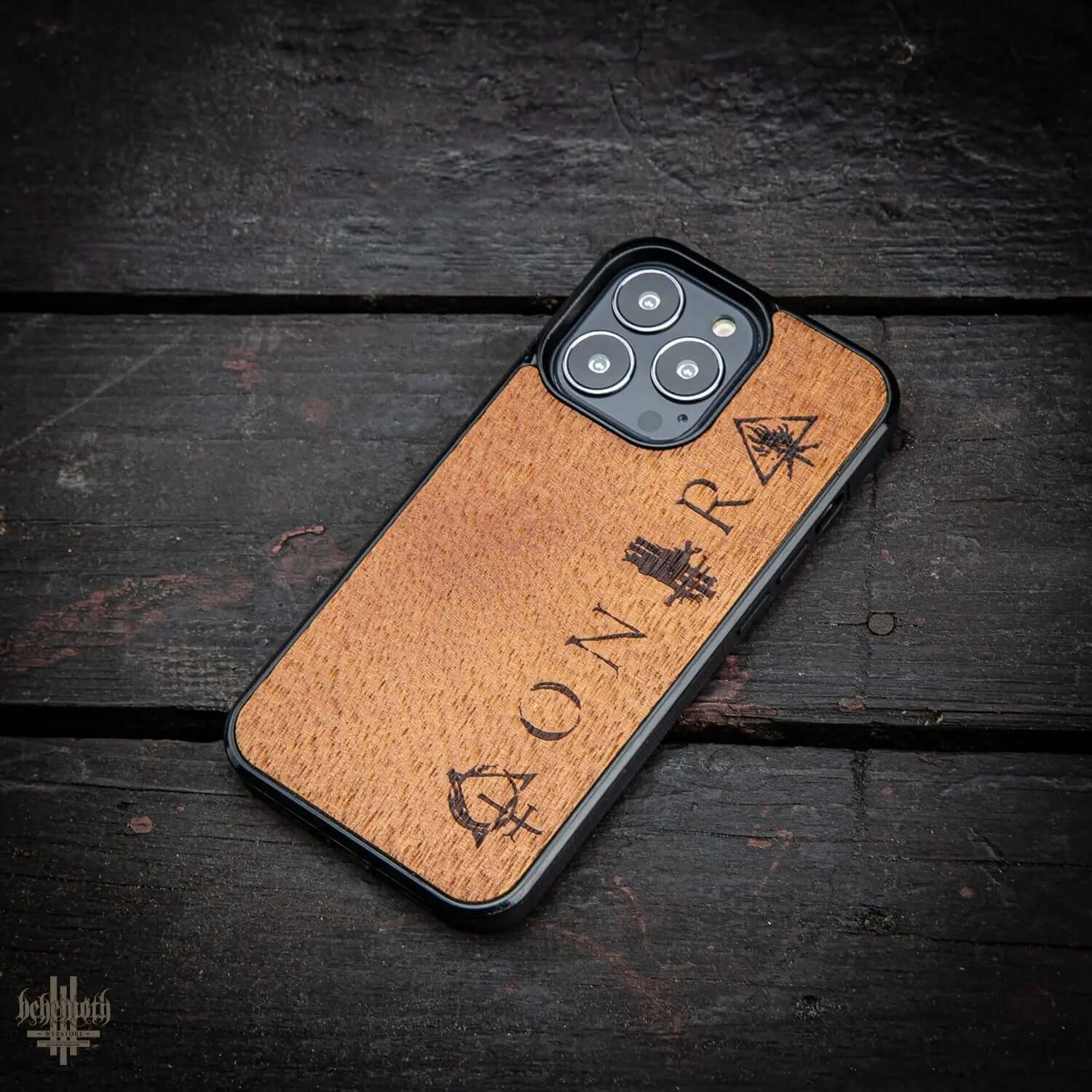 iPhone 13 Pro case with merbau wood finish, Behemoth 'CONTRA' logo, hand-finished, made in Poland, impact-resistant polycarbonate base.