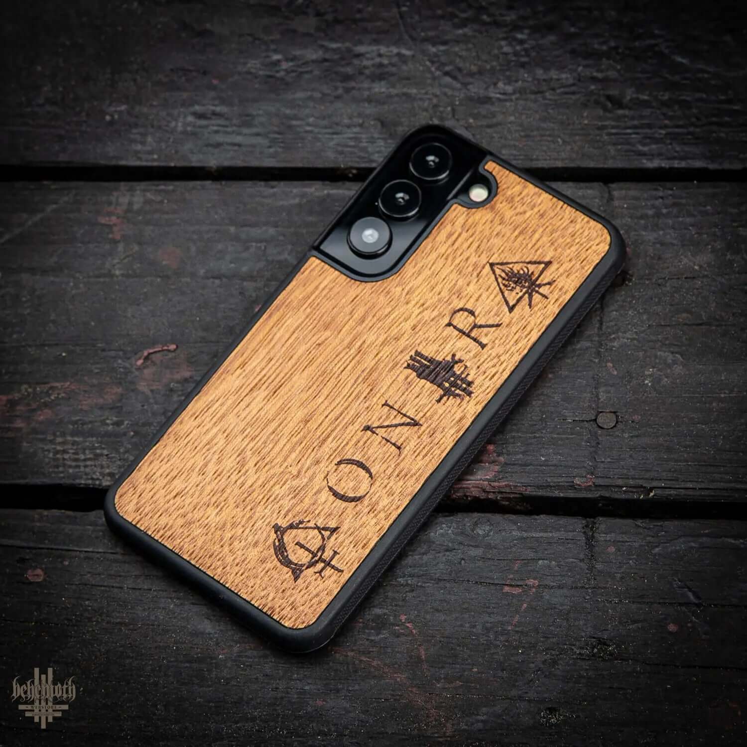 Samsung Galaxy S22 case with merbau wood finish and Behemoth 'CONTRA' logo, hand-finished, on black background.
