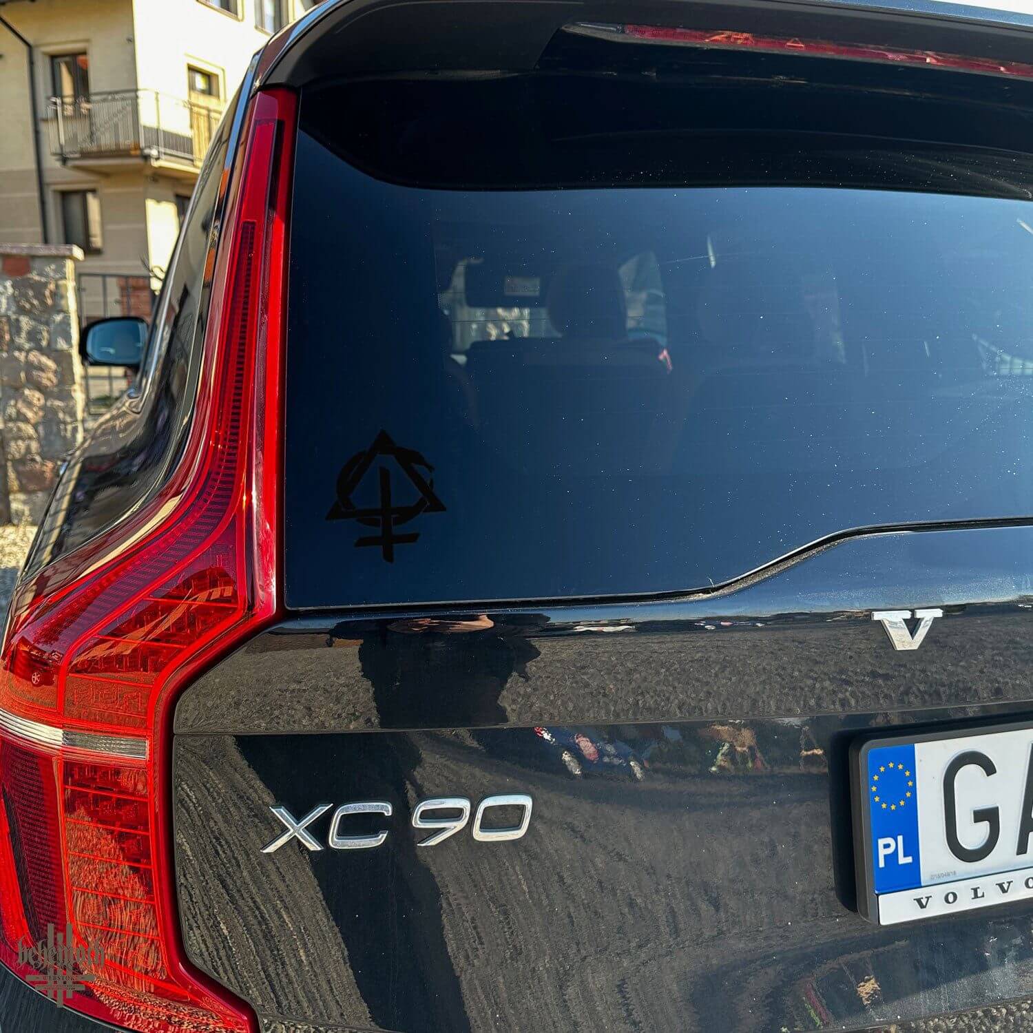 Vinyl sticker with Contra design on car window, black matte finish, seen on a Volvo XC90 rear windshield, Behemoth Webstore product.