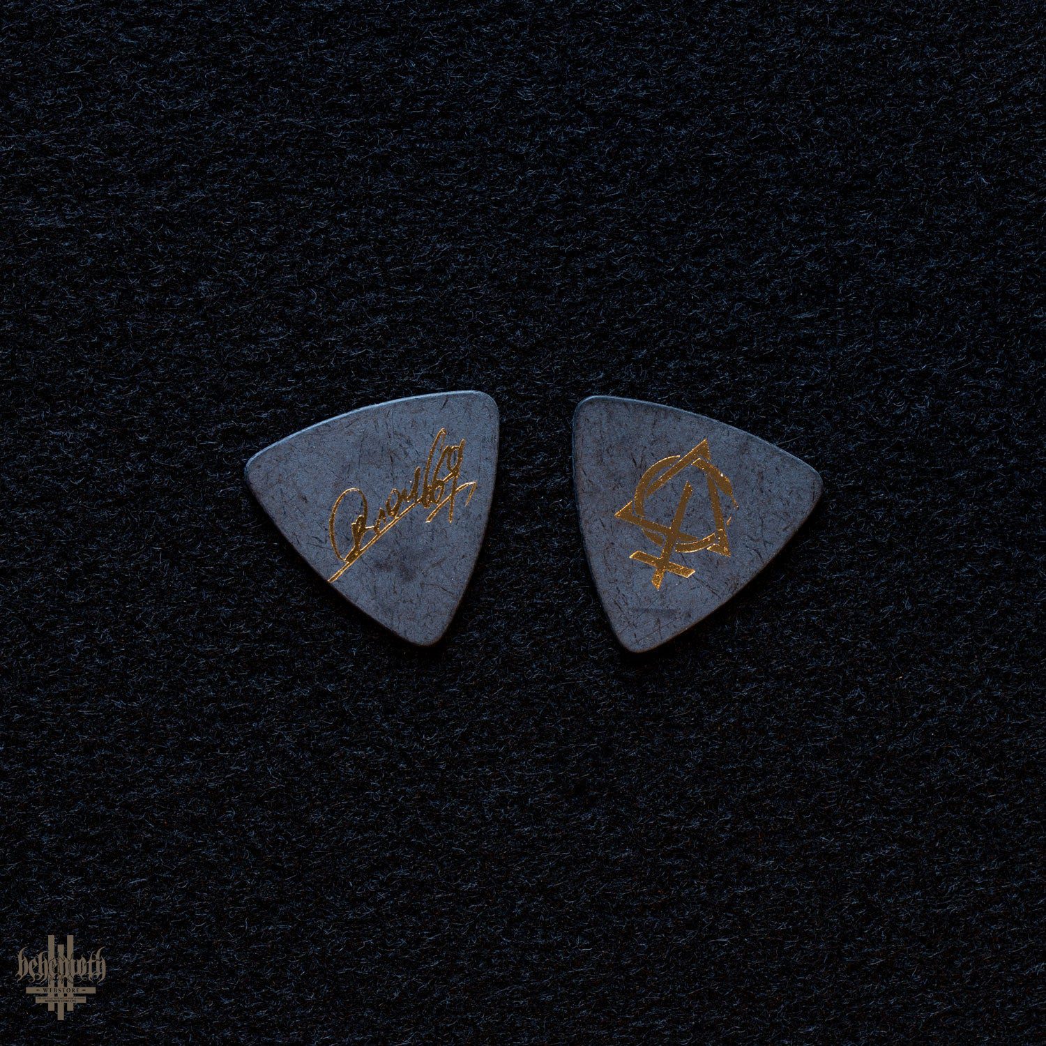 Plastic guitar pick with Behemoth 'Contra' Orion signature, 0.88 mm thickness, featuring gold print on a dark background.