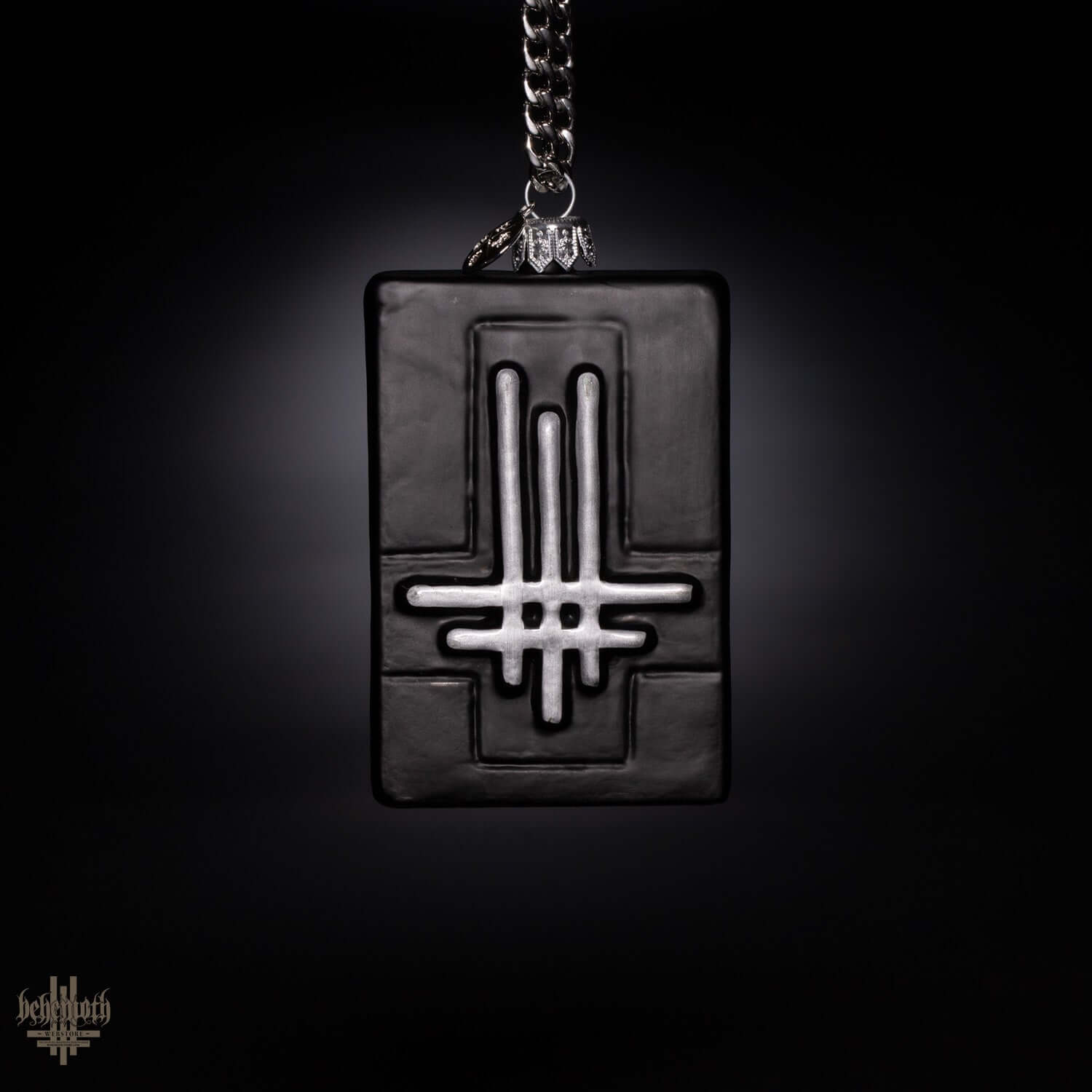 Dark blown glass ornament from the Behemoth Gift Set, featuring a unique hand-painted design on a black rectangular shape.