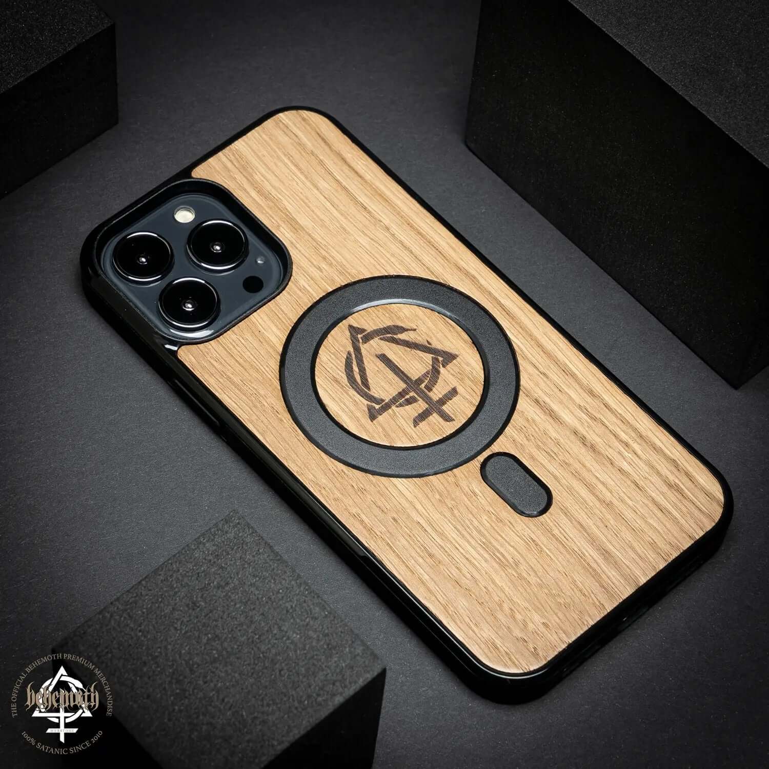 iPhone 13 Pro Max case with oak wood finish, featuring Behemoth 'CONTRA' logo, hand-finished in Poland.