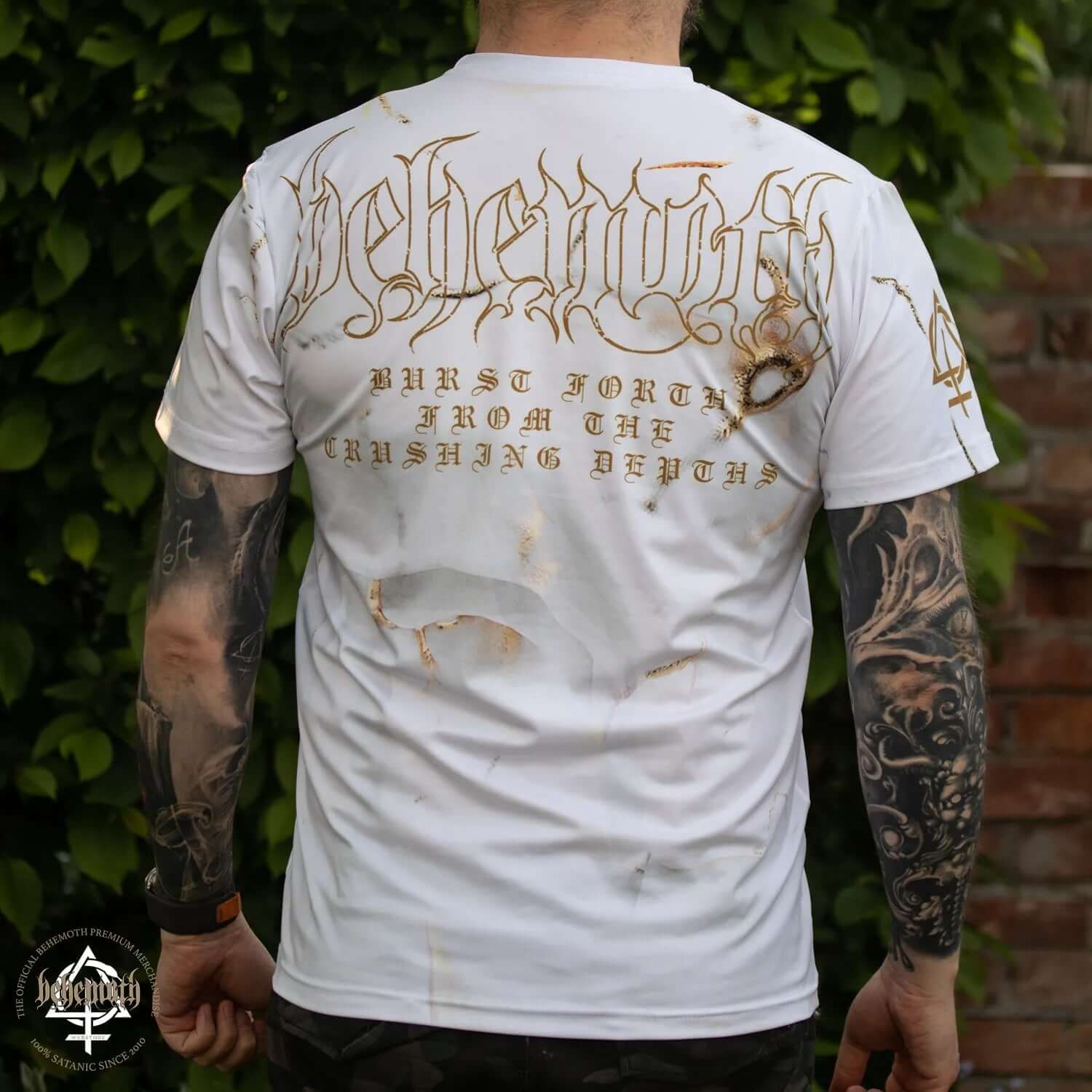 Man wearing Behemoth 'Skull' all-over print t-shirt with tattooed arms, showing unique design on back