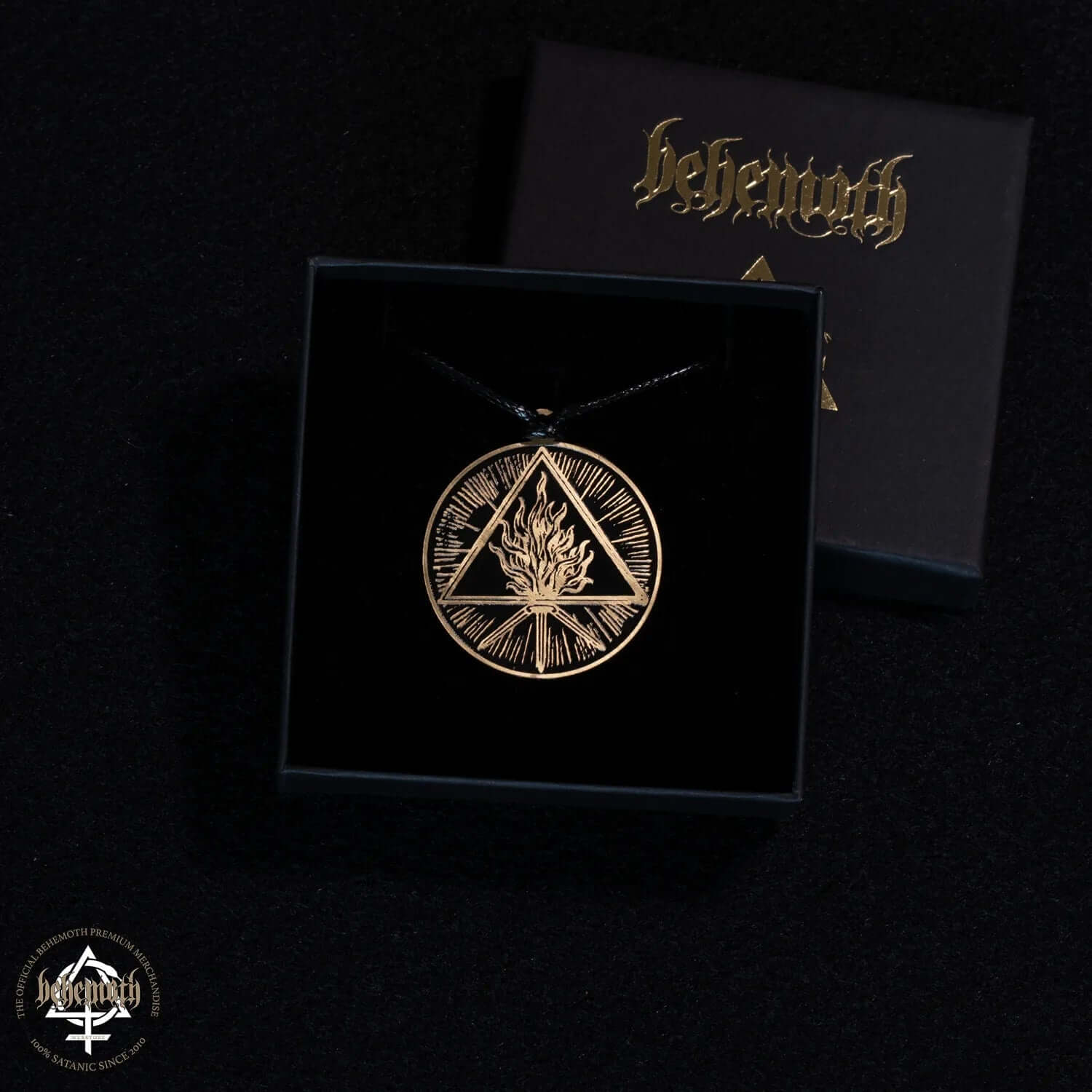 Behemoth 'The Unholy Trinity' patinated brass necklace with intricate design in a black presentation box, featuring a strap.