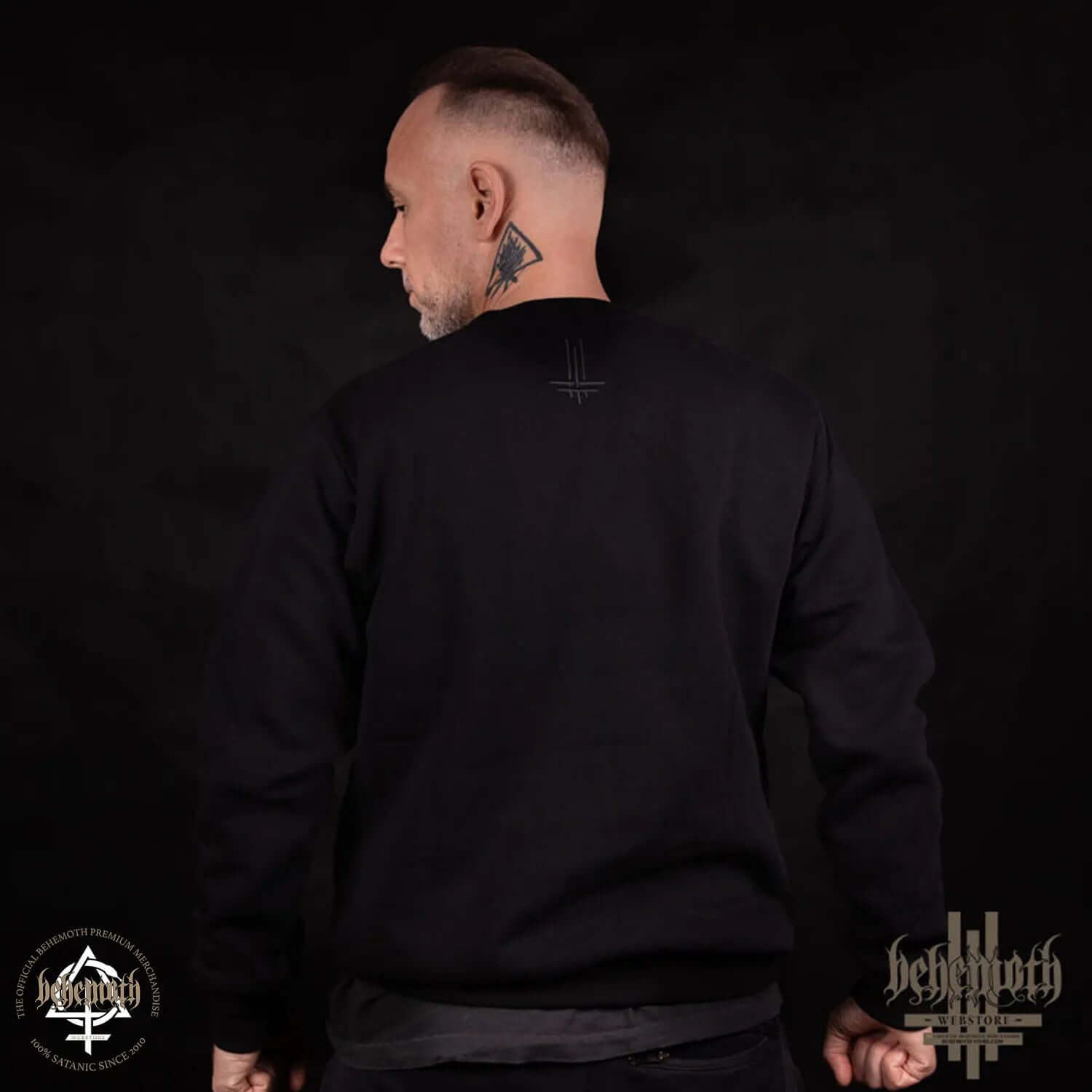 Man wearing black Behemoth Logo crewneck sweatshirt with Trivmviratvs emblem on neck, premium quality, made in Poland.