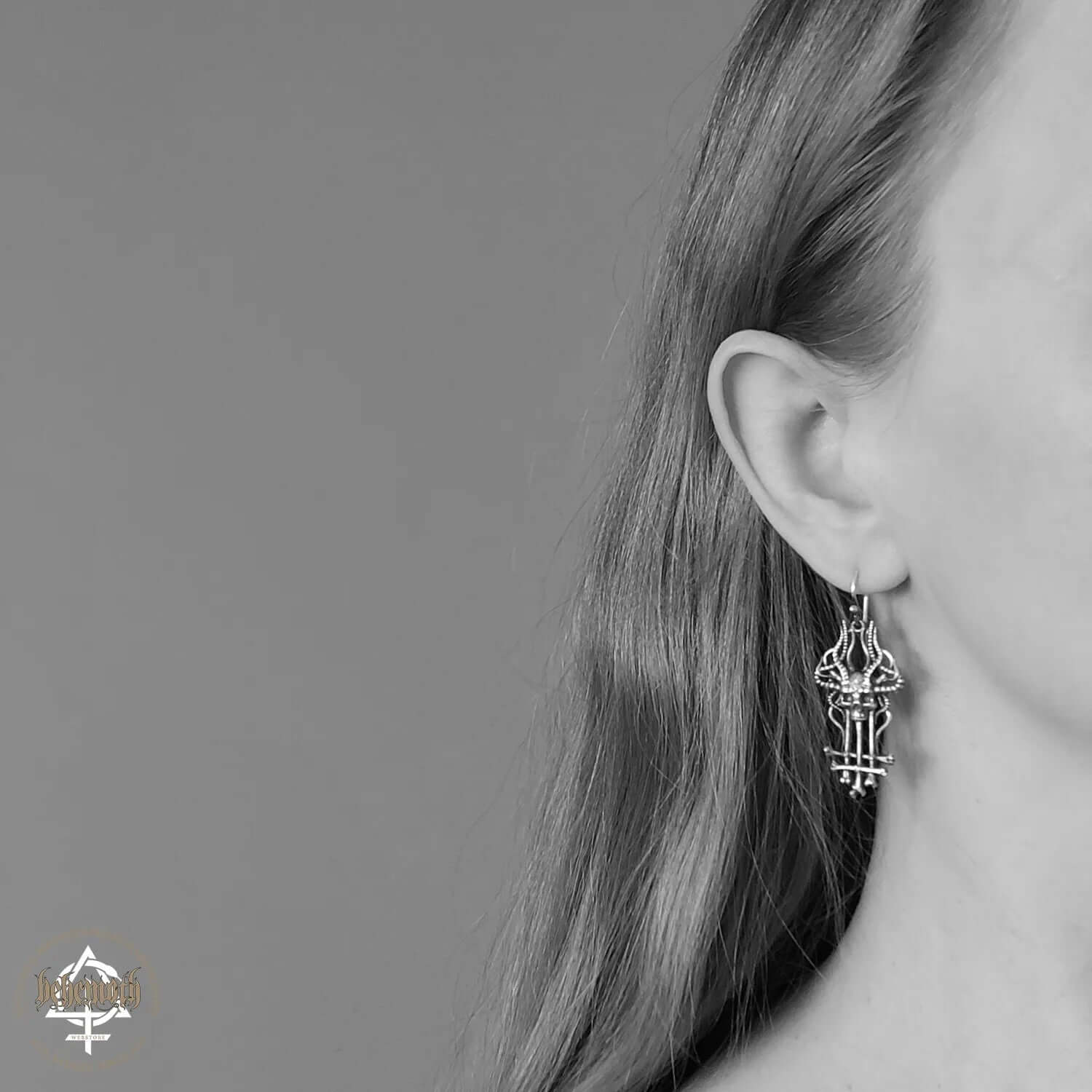 Woman wearing 'In Absentia Dei' Behemoth sterling silver earrings with intricate design by Anna Mazon Jewellery.