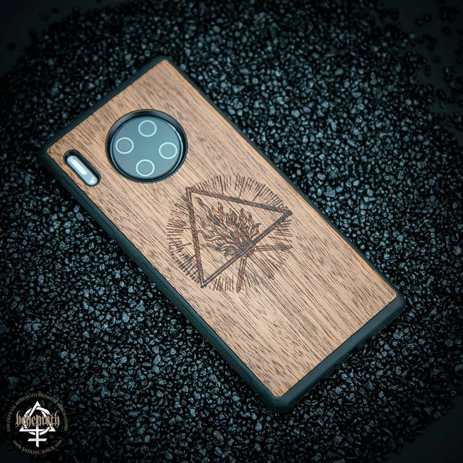 Huawei Mate 30 PRO case with wood finishing and engraved 'The Unholy Trinity' logo, made from merbau wood, on black stones.