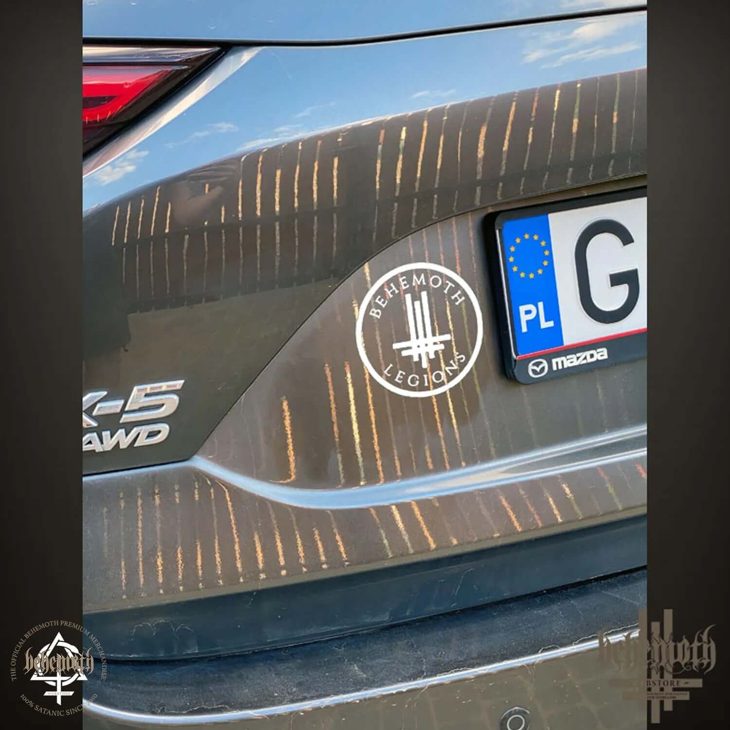 Behemoth Legions white decal on Mazda car, rear view, smooth application to clean surface. Ideal for car windows or bodies, size 10 cm.