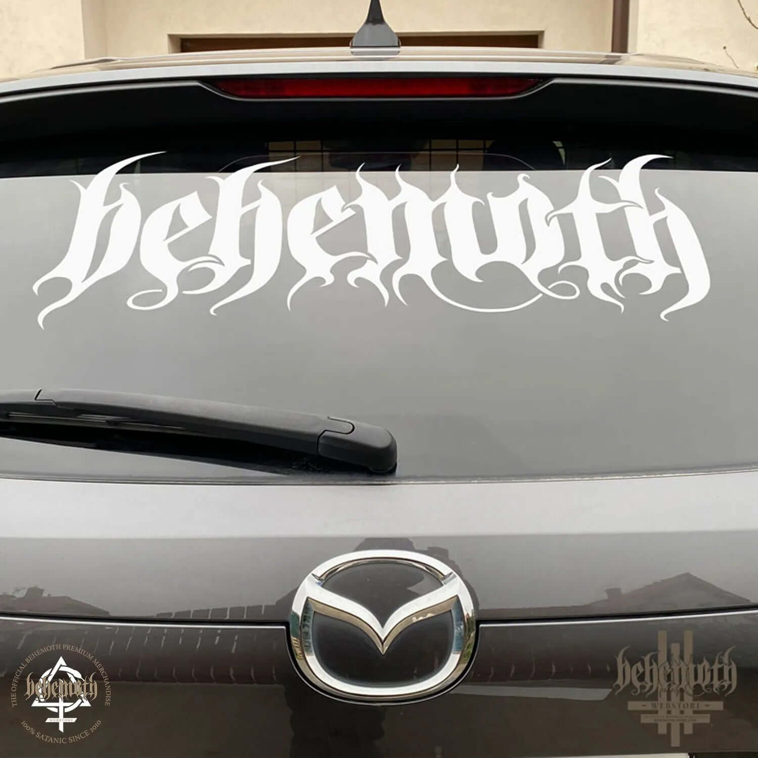 Large white Behemoth logo vinyl sticker on car window, showcasing matte decal design, ideal for smooth surfaces.