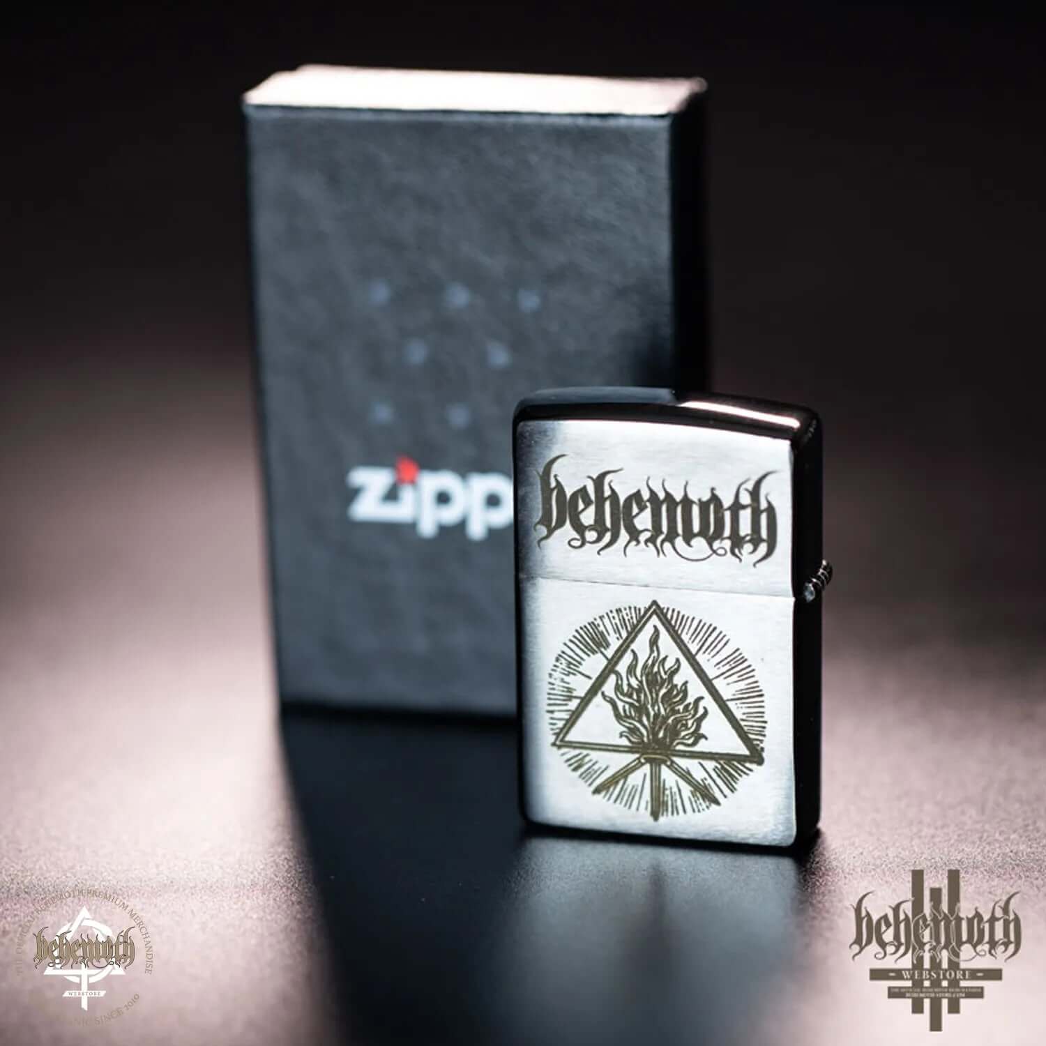 Behemoth ZIPPO 'The Unholy Trinity' windproof lighter in brushed chrome with engraved design, shown with original packaging.