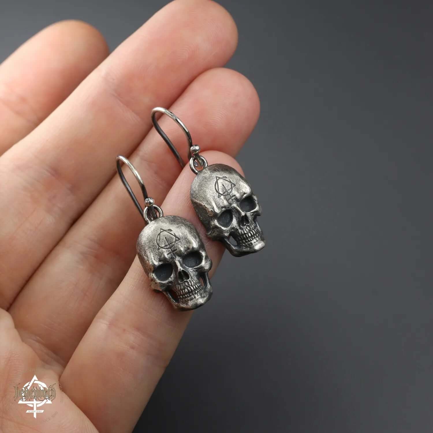 Sterling silver skull earrings, hand-sculpted using lost wax technique, polished and oxidized for detail, by Anna Mazon Jewellery.