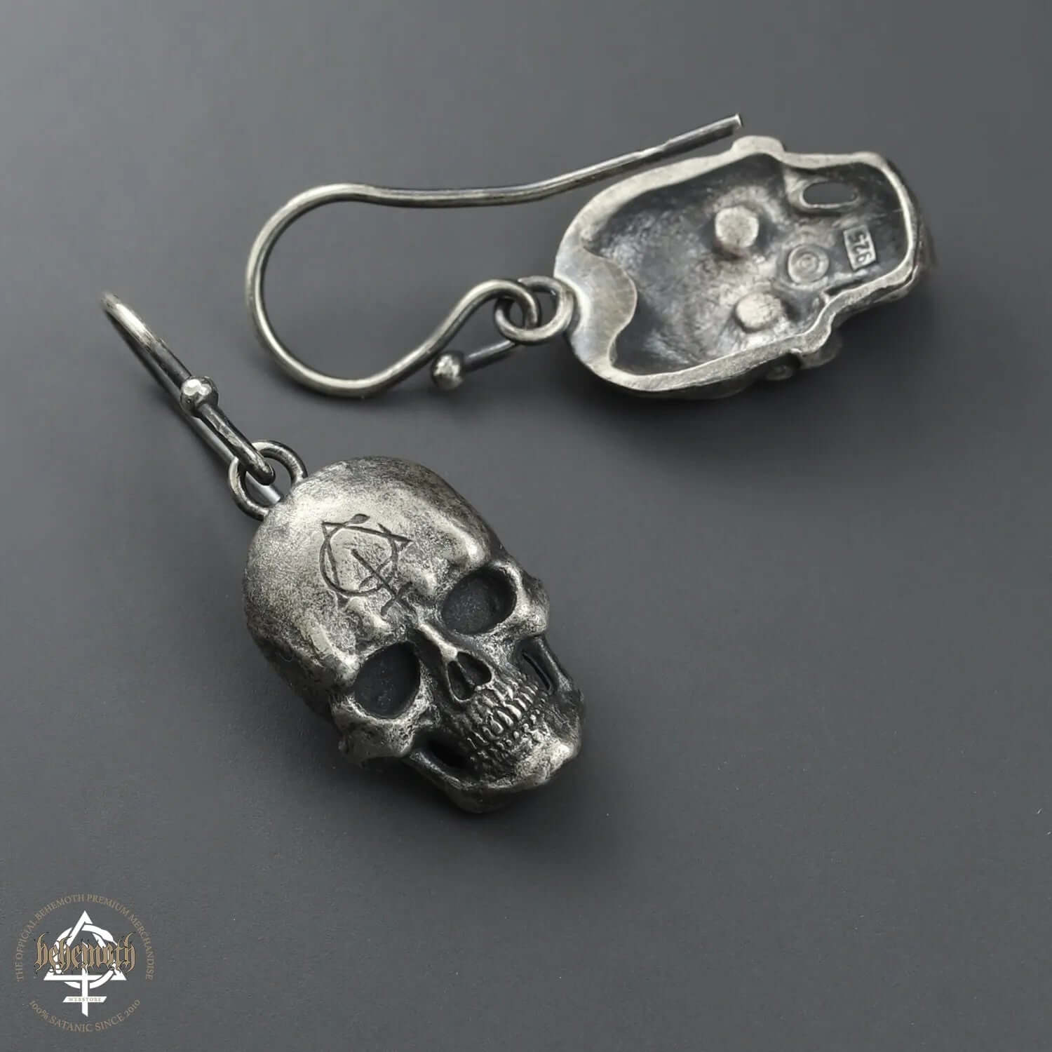 Behemoth 'Contra Skull' sterling silver earrings, hand-sculpted and oxidized, showcasing detailed skull design by Anna Mazon.