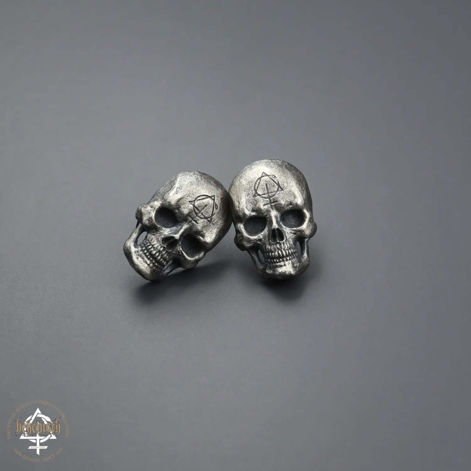 Behemoth 'Contra Skull' sterling silver stud earrings with darkened finish, hand sculpted and polished, showcasing intricate details.