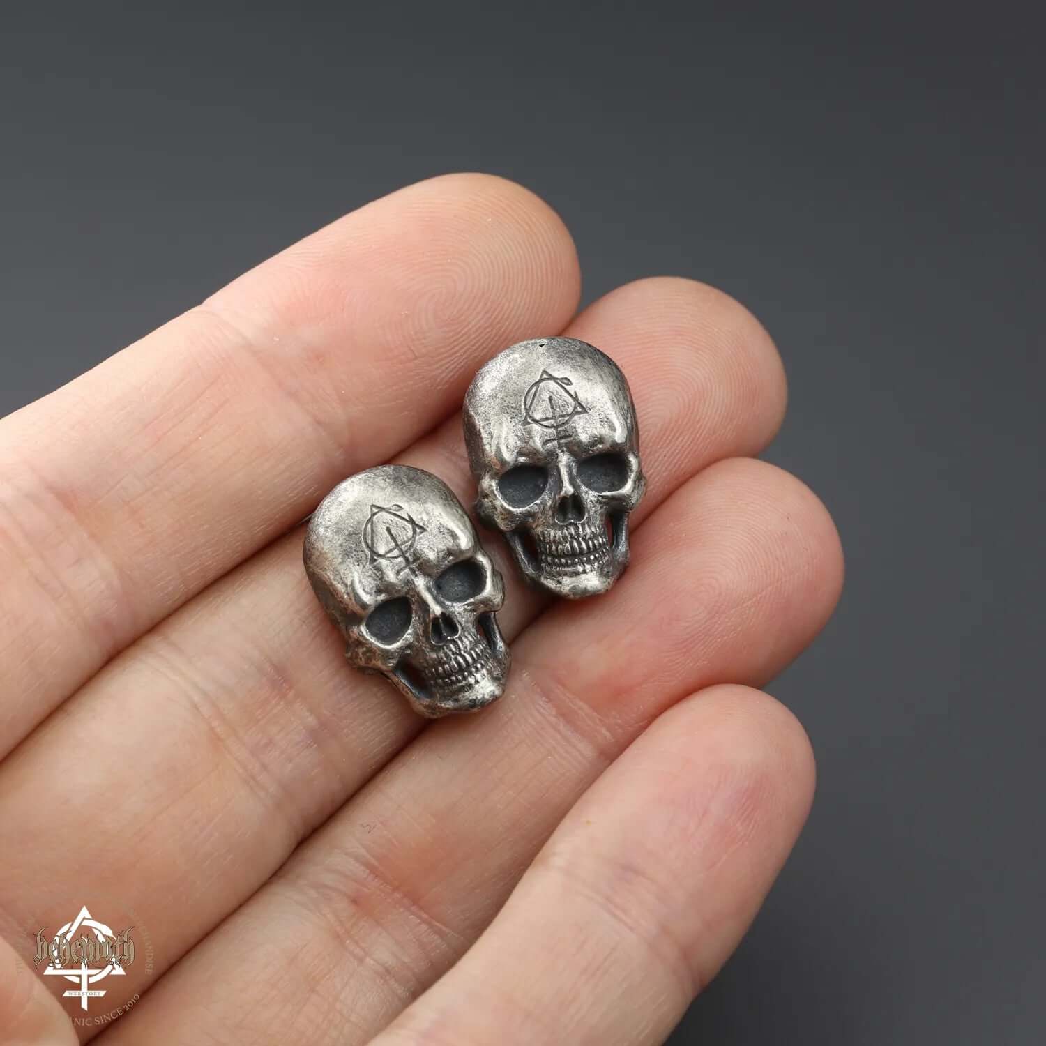 Sterling silver skull stud earrings, hand sculpted with oxidized finish, showcasing intricate details and dark, edgy design by Anna Mazon.