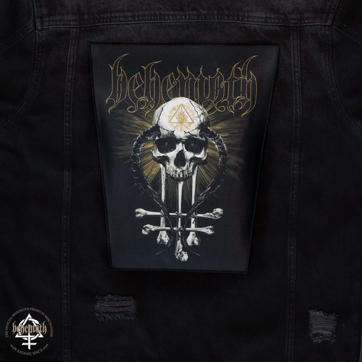 Behemoth 'In Absentia Dei' skull and cross design iron-on back patch on black jacket, featuring gold and silver detailing.