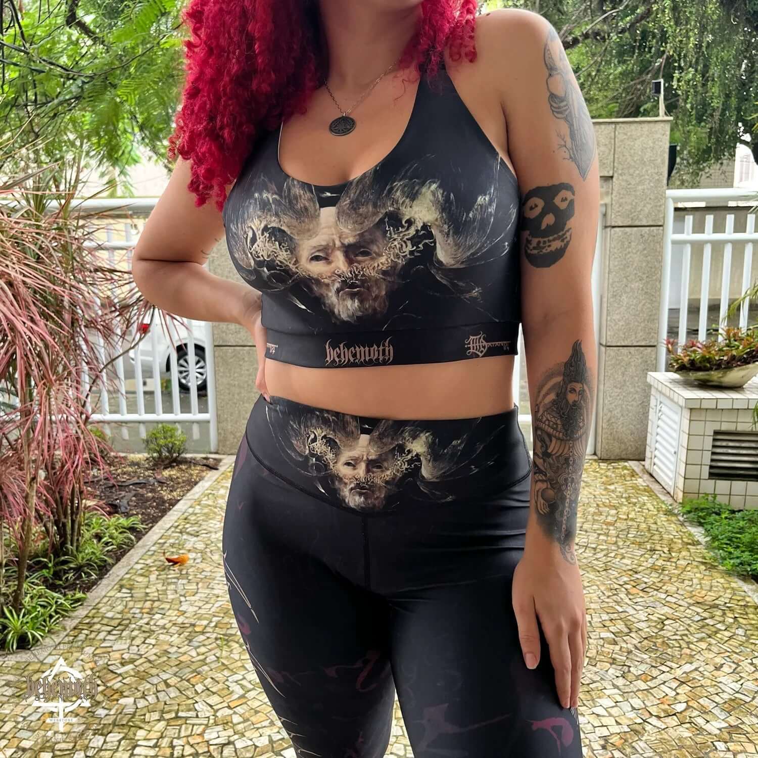 Woman wearing Behemoth 'The Satanist' sports bra, showcasing Dani Batista prints; ideal for running, gym, and yoga activities.
