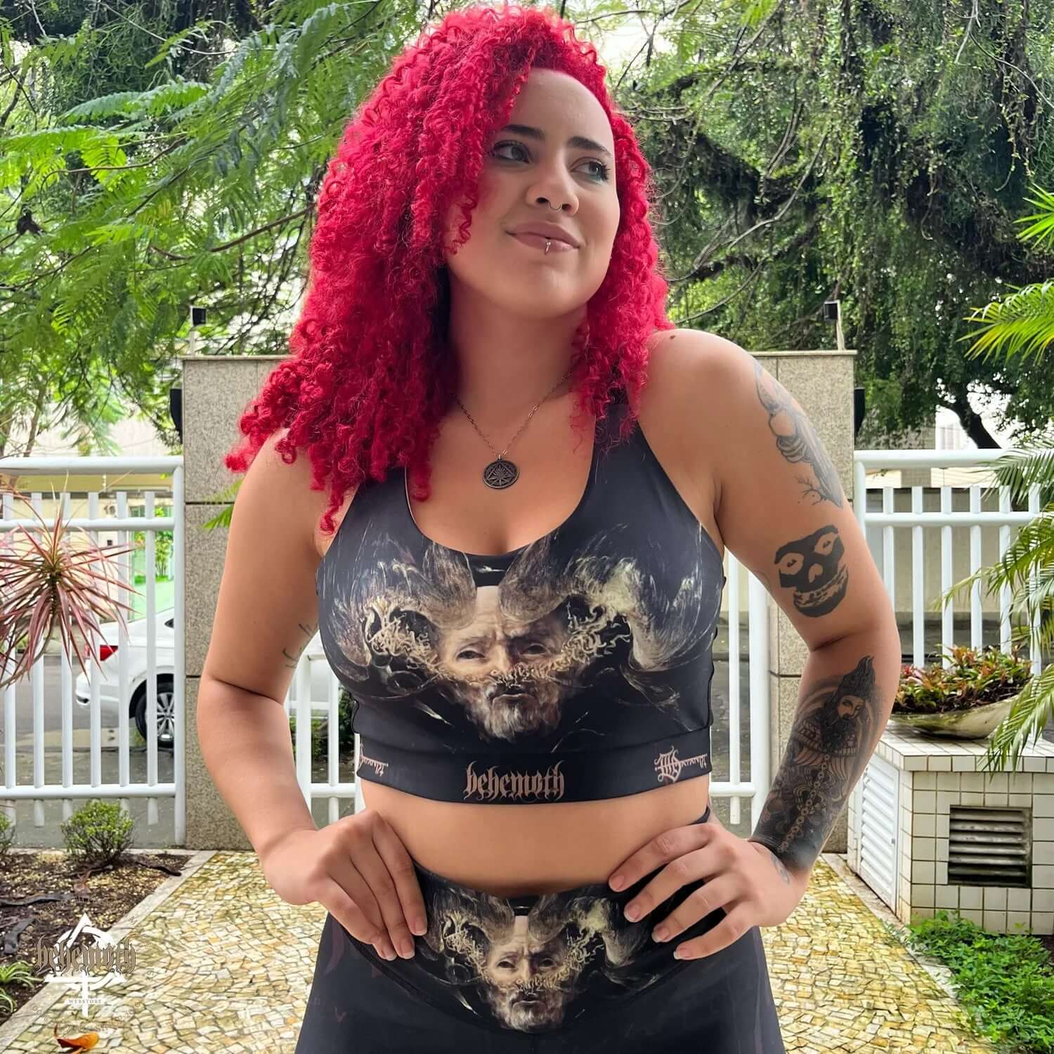 Woman wearing Behemoth 'The Satanist' sports bra with unique print for running, fitness, and yoga; features reinforced straps.