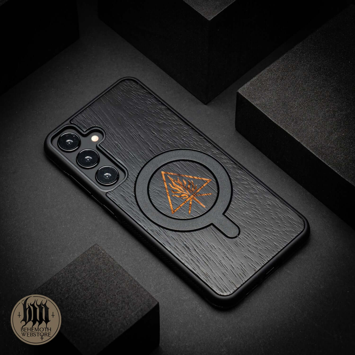 Behemoth 'The Unholy Trinity' black oak MagSafe phone case, hand-finished in Poland, showcasing precision craftsmanship.