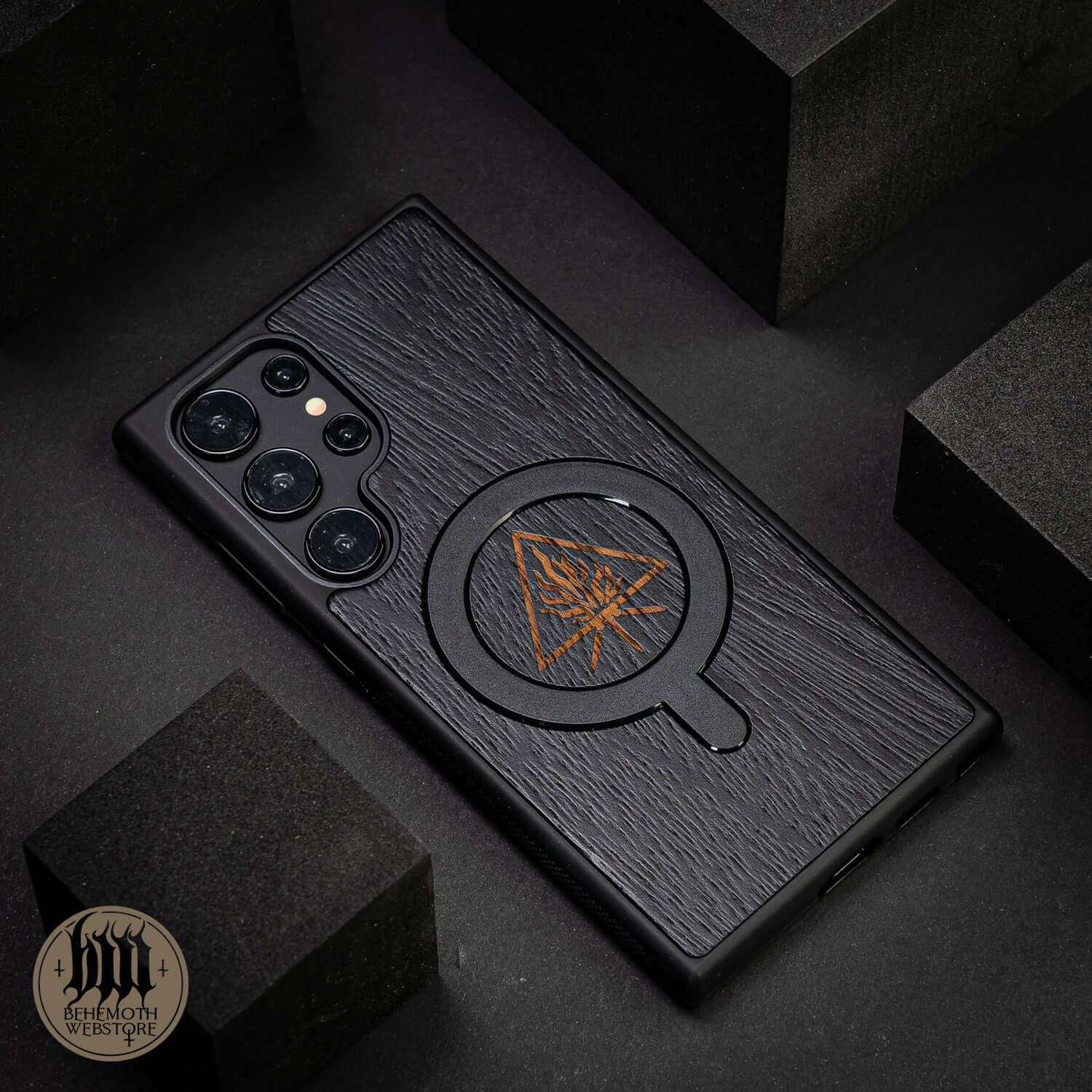 Behemoth 'The Unholy Trinity' black wooden MagSafe phone case made from oak, featuring precise craftsmanship, made in Poland.