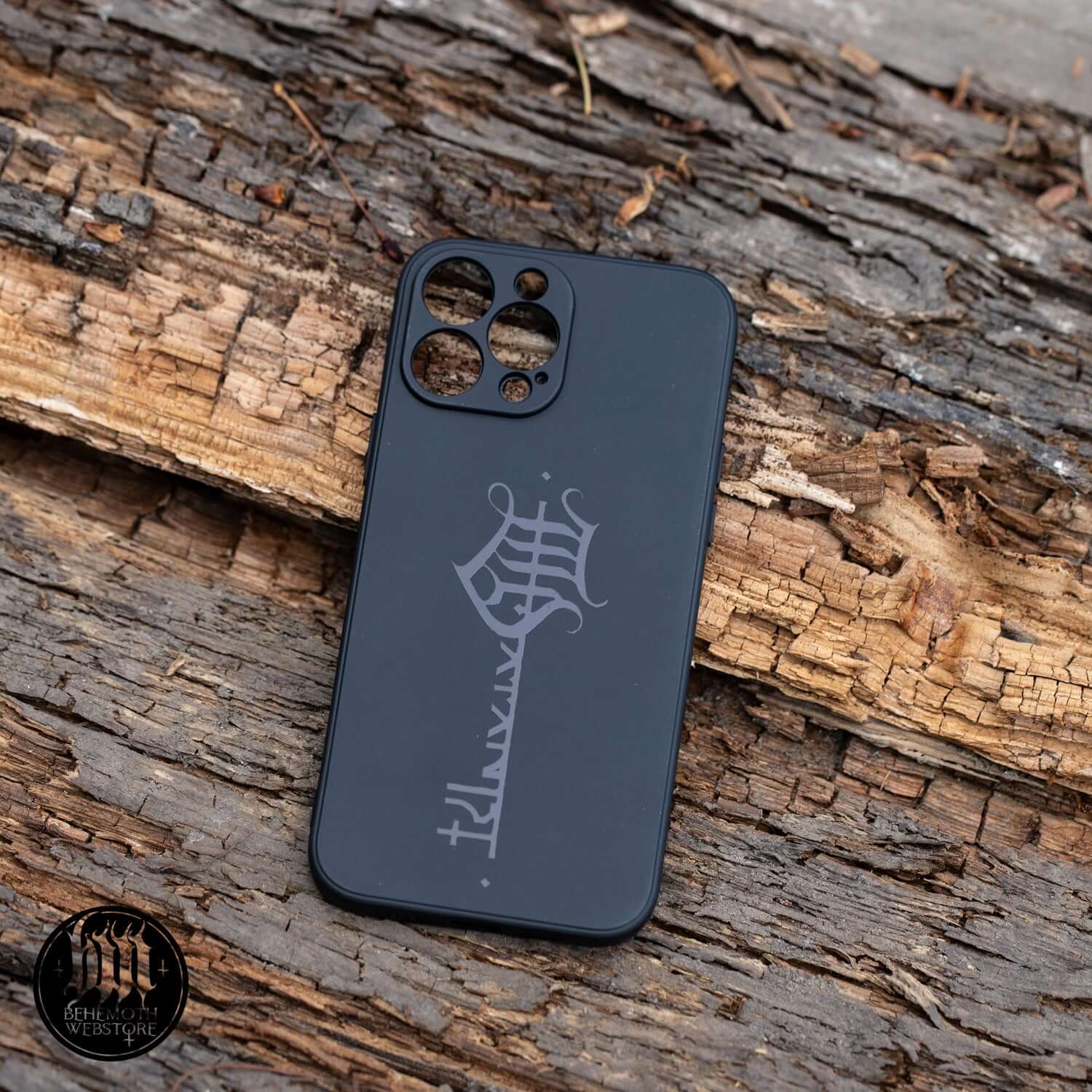 Black Behemoth 'The Satanist' phone case with glossy key sigil design on wood background, non-slip matte finish, phone protection.