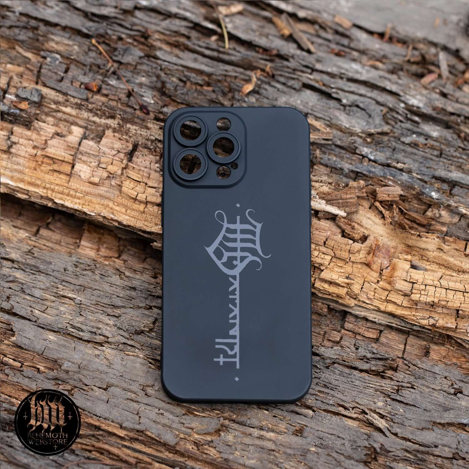 Black Behemoth 'The Satanist' phone case with matte finish and sigil design on wood background.
