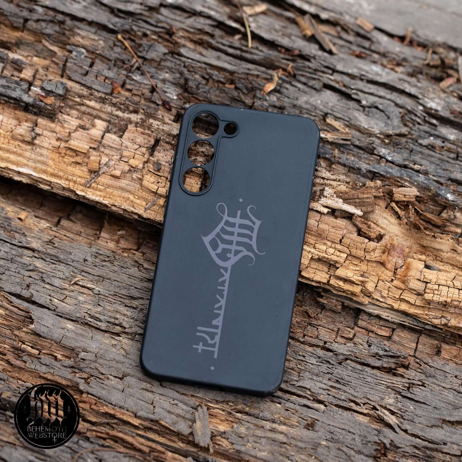 Behemoth 'The Satanist' black matte silicone phone case with key sigil, protecting phone with stylish design on wooden background