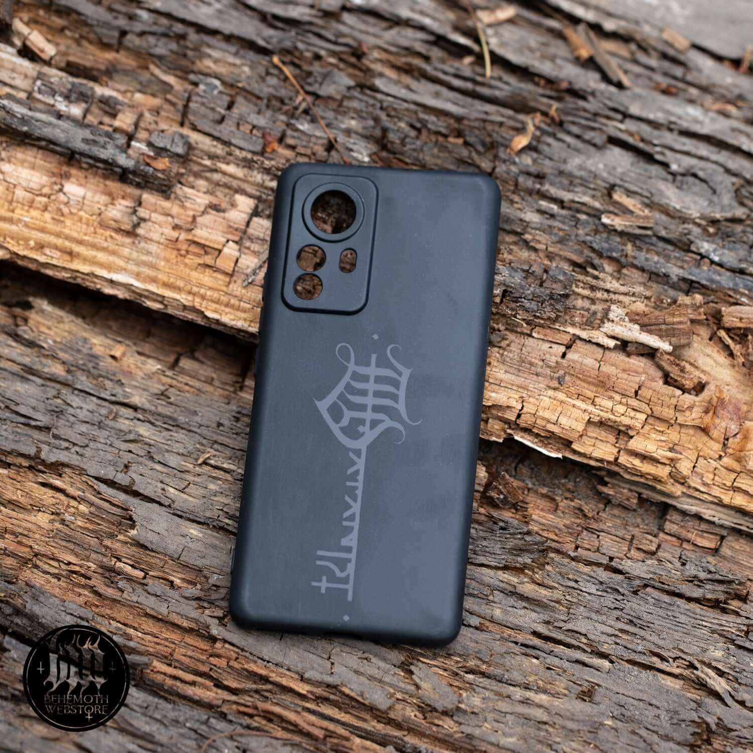 Behemoth 'The Satanist' silicone phone case with black matte finish and glossy sigil, providing durable protection and non-slip grip.