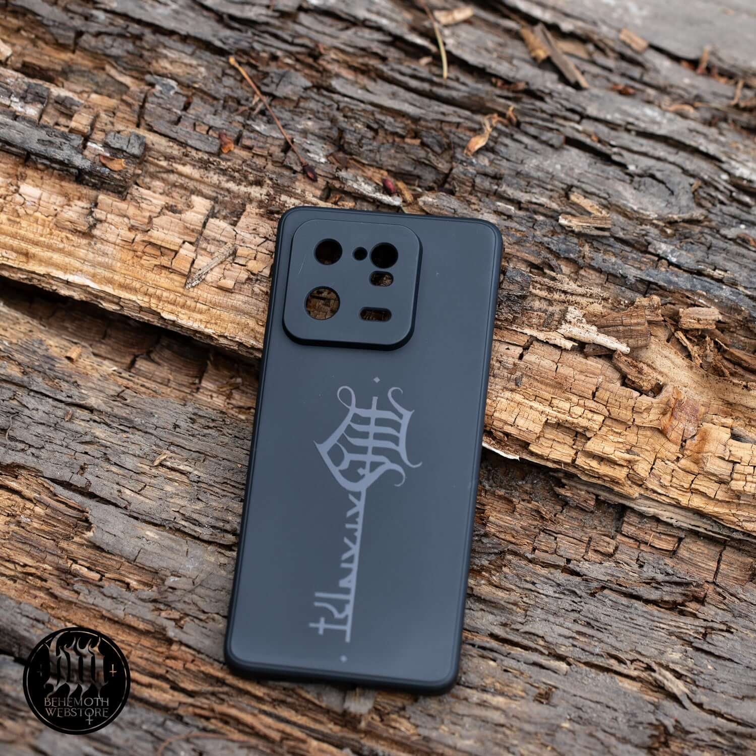 Behemoth 'The Satanist' phone case with black matte finish and glossy key sigil, high-quality silicone, non-slip design on rugged surface