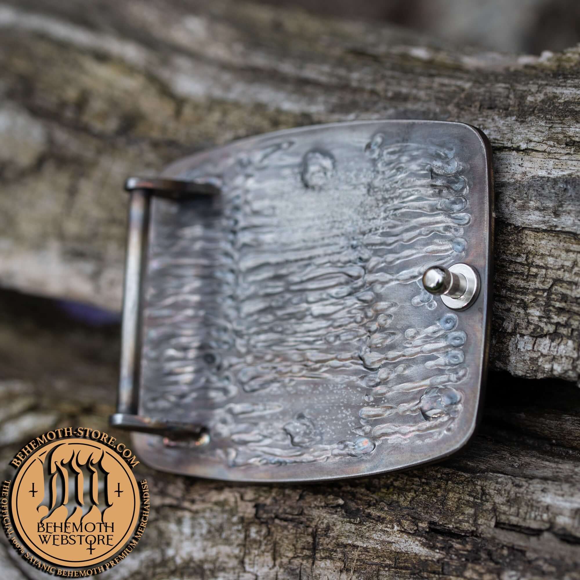 Back view of Behemoth 'The Unholy Trinity' stainless steel belt buckle showing craftsmanship detail and Behemoth Webstore logo.