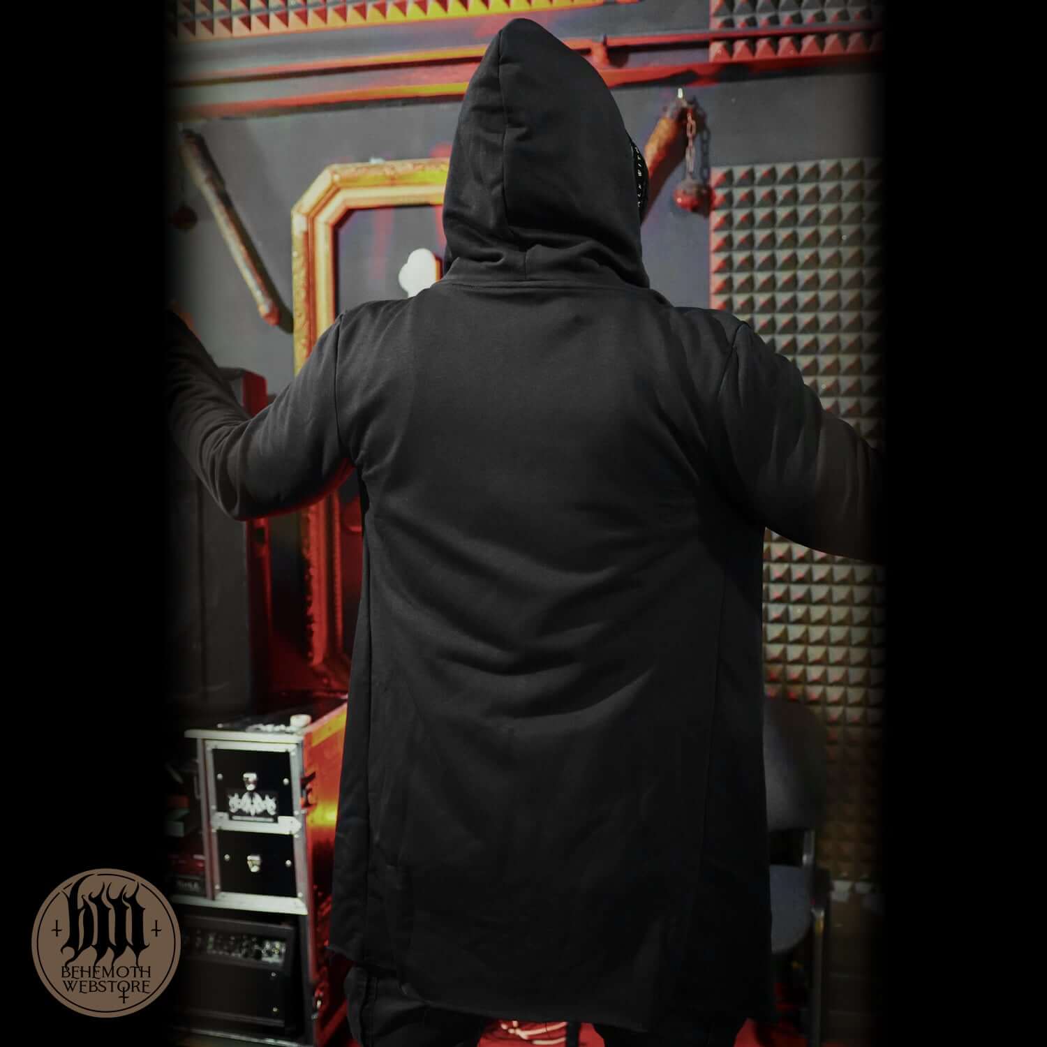 Back view of Behemoth 'Contra' long hooded open edge cardigan in black, featuring an oversized hood and vintage aesthetic.
