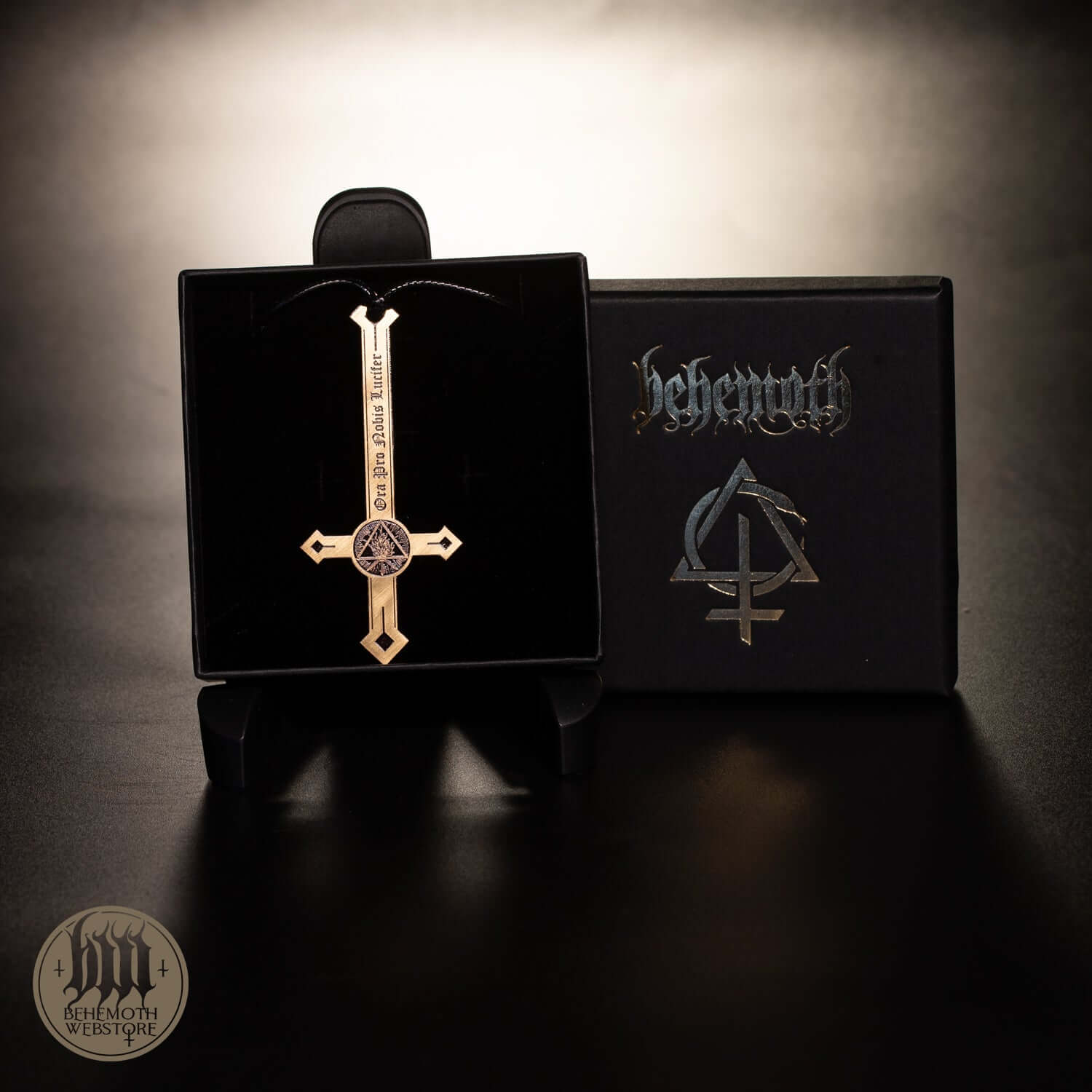 Behemoth 'Ora Pro Nobis Lucifer' brass necklace on display with ornate cross design.