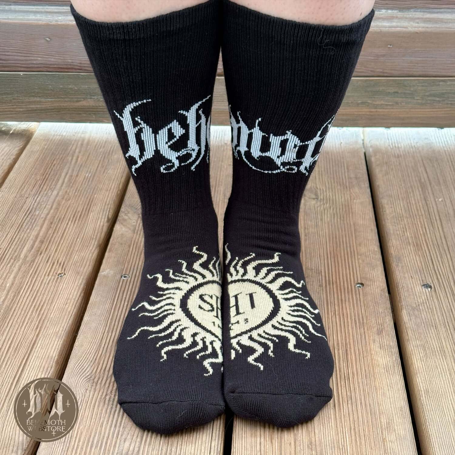 Person wearing 'The Feet Ov God' Behemoth mid-calf socks with bold logos and sigil design, styled for durability and comfort.
