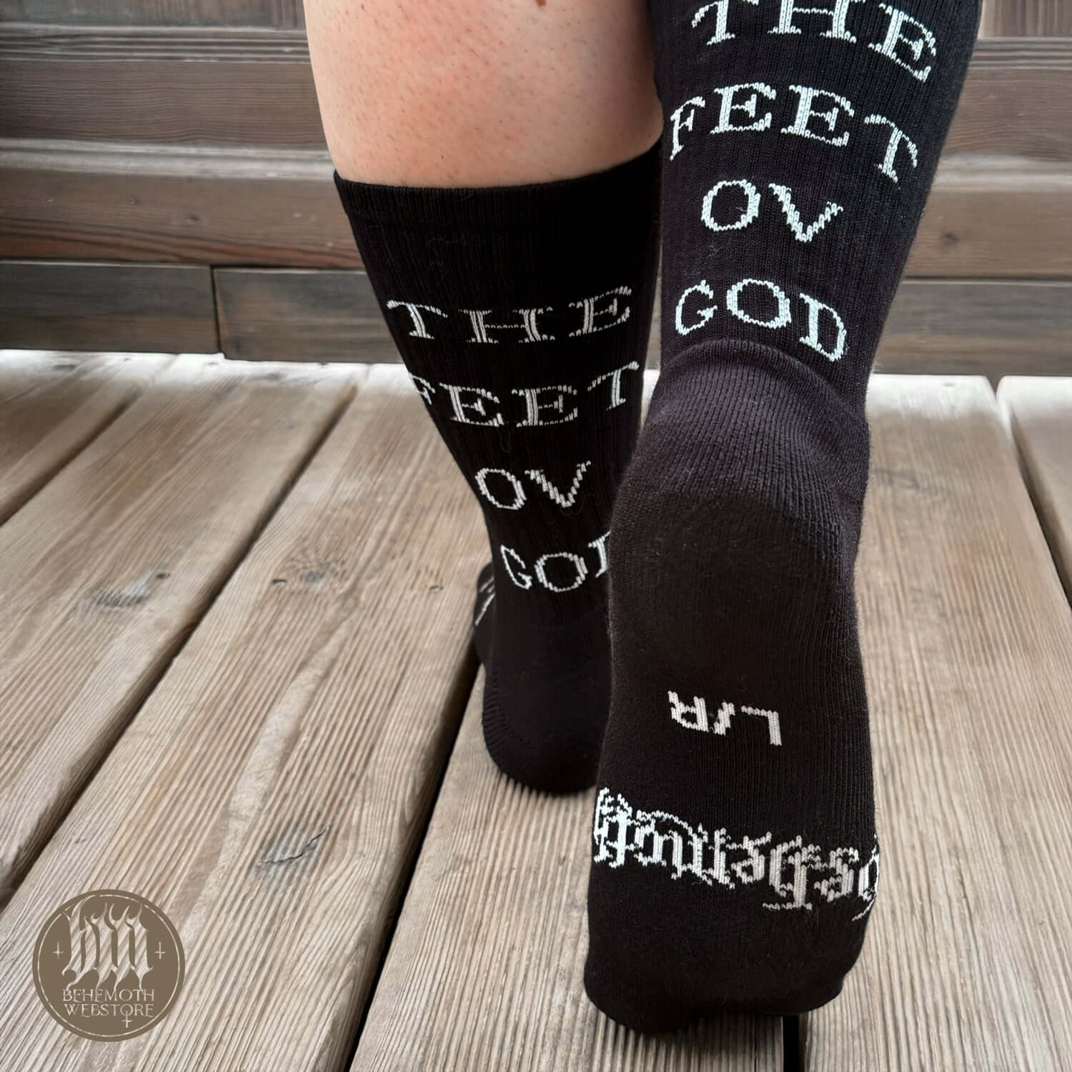 Premium black mid-calf Behemoth socks with 'The Feet Ov God' text, featuring logos and sigils for fans of bold, durable footwear.