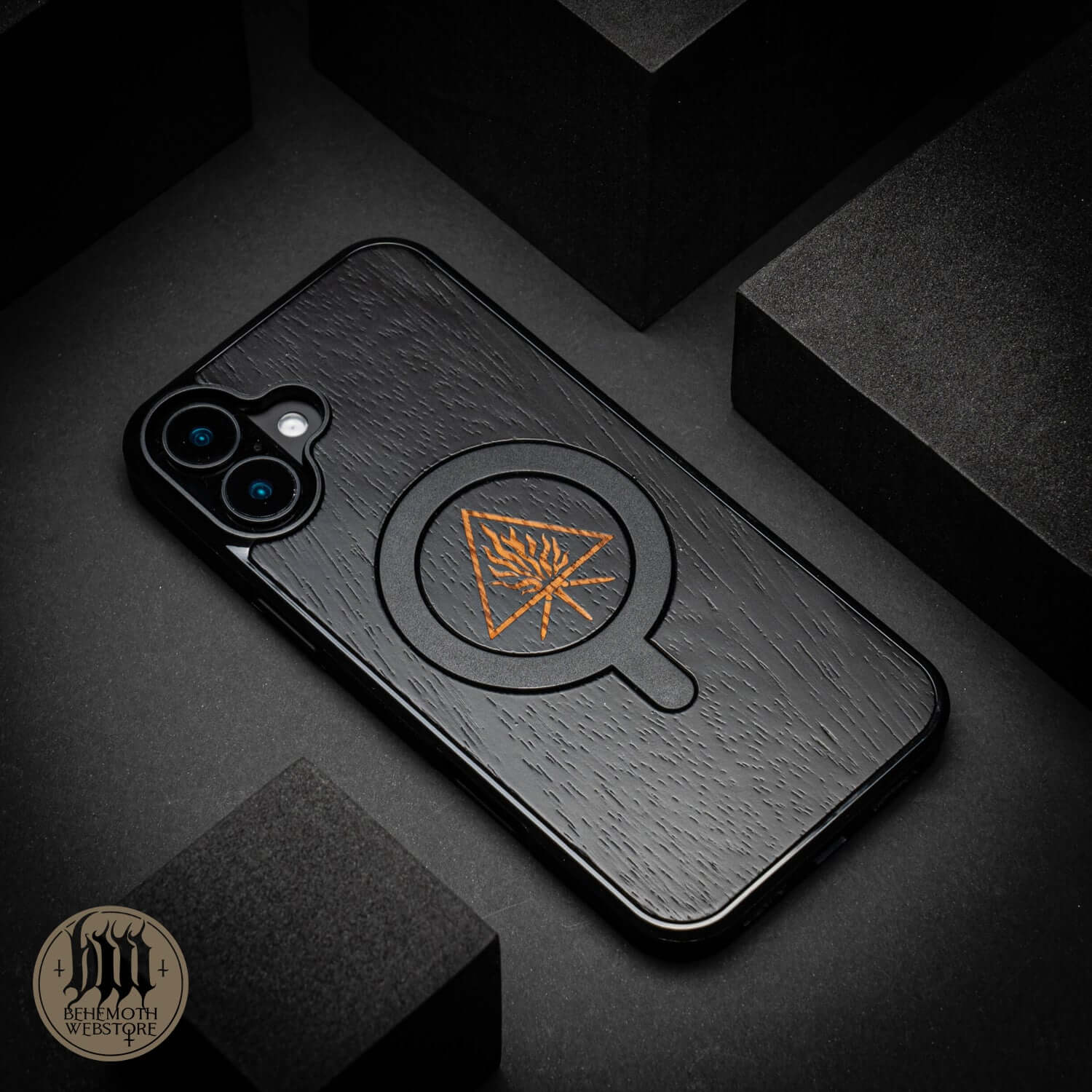 Behemoth 'The Unholy Trinity' black oak MagSafe phone case with intricate design, made in Poland.