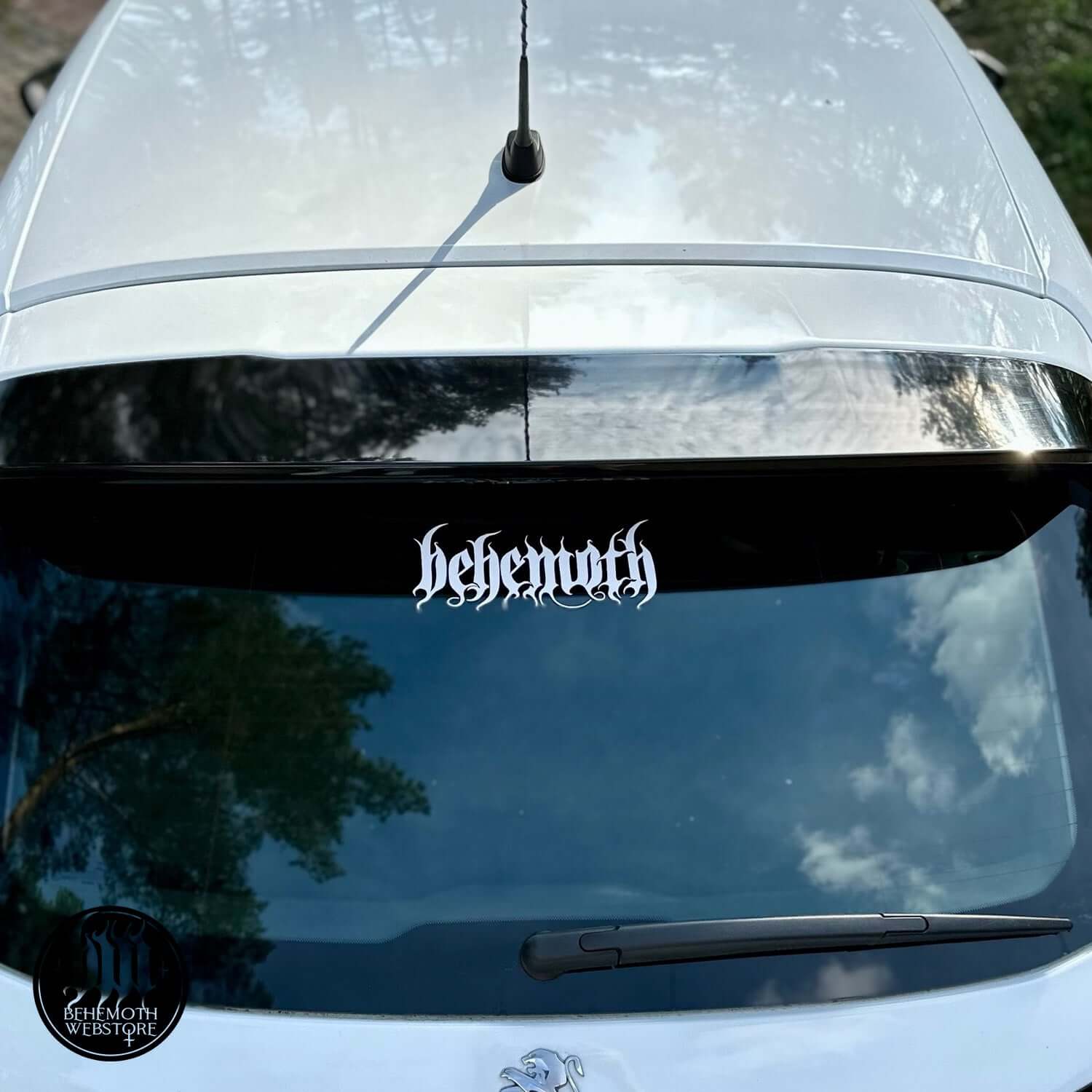 White Behemoth logo vinyl sticker on car window, suitable for smooth surfaces, measures 20cm x 8cm, from Behemoth Webstore.