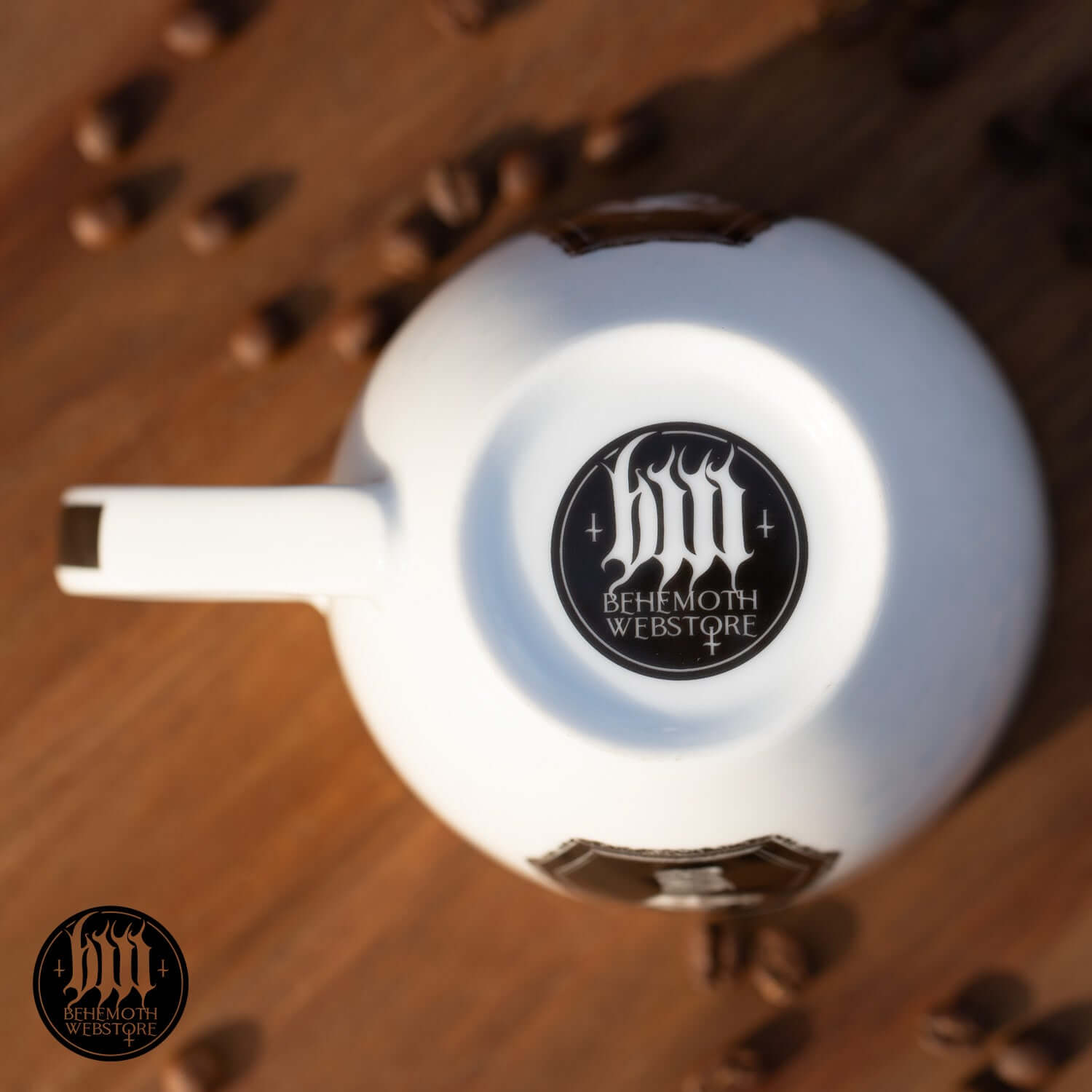Top view of Behemoth 'Polonaise Satanique' mug featuring Behemoth Webstore logo, surrounded by scattered coffee beans.
