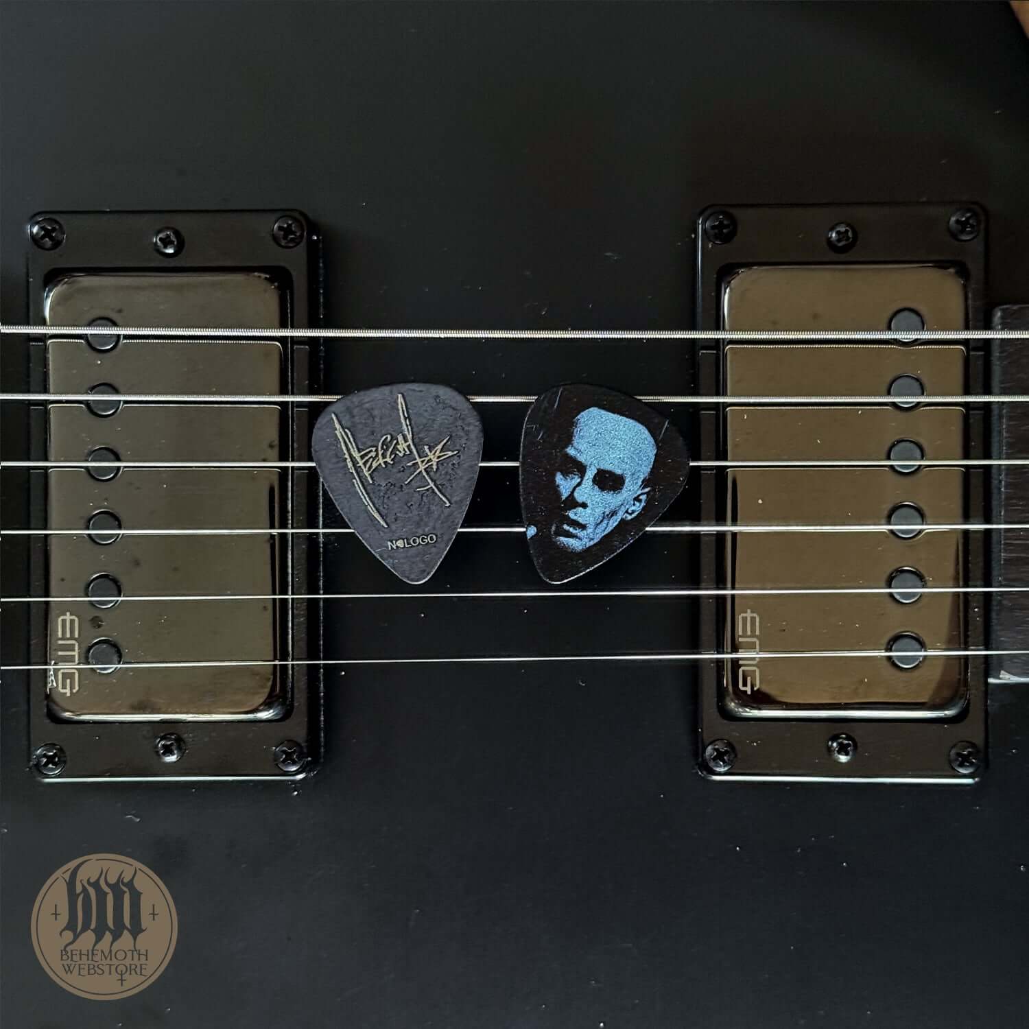 Nergal signature plastic guitar pick with 'Face' design on electric guitar strings, 1 mm thickness, perfect for musicians.
