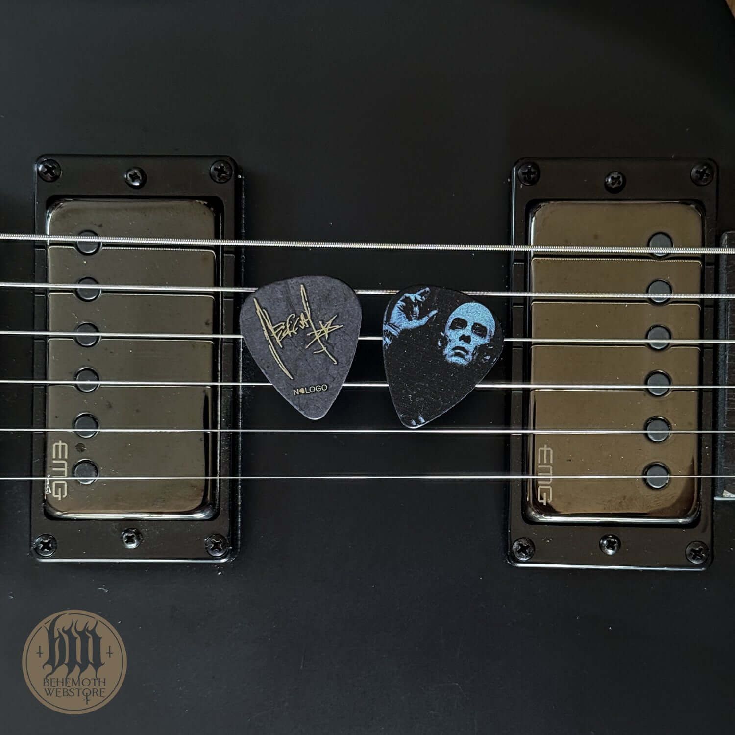 Nergal signature plastic guitar pick with 'Hand' design on black guitar strings, 1mm thickness, ideal for music enthusiasts.