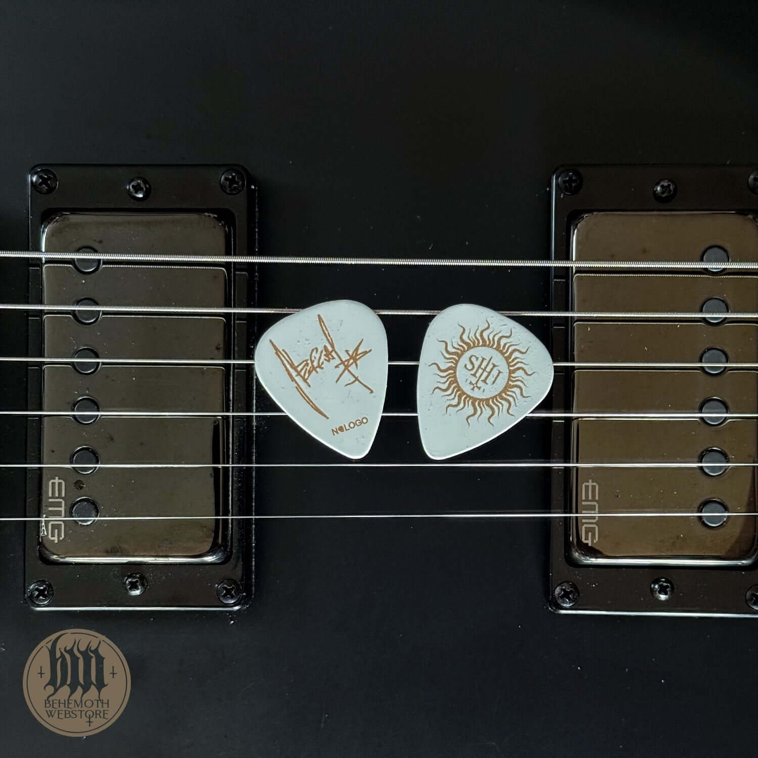 Nergal signature TSOG Sigil white guitar picks on electric guitar strings, 1mm thickness, ideal for music enthusiasts.