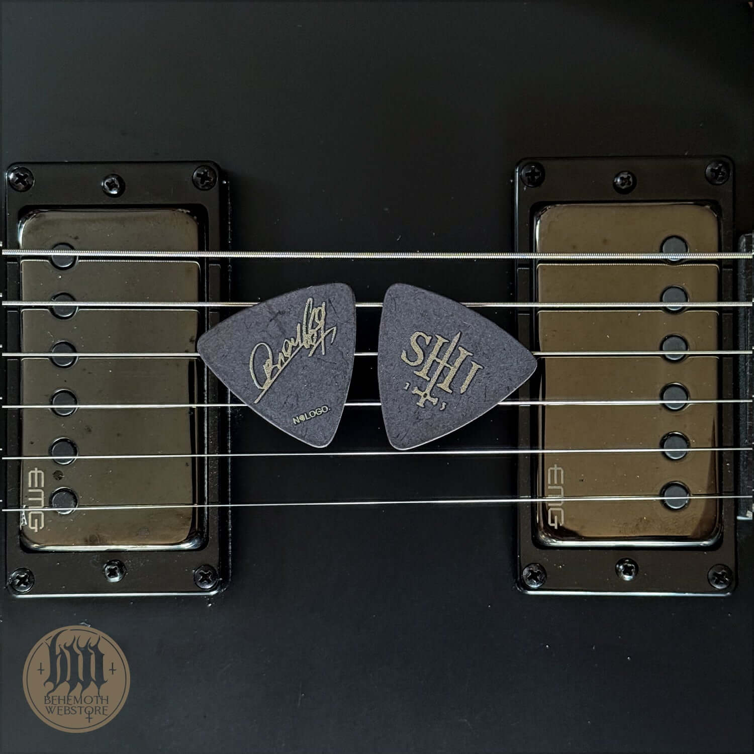 Orion signature guitar picks with 'SHIT' design on electric guitar strings, 0.88 mm thickness, perfect for distinctive sound.
