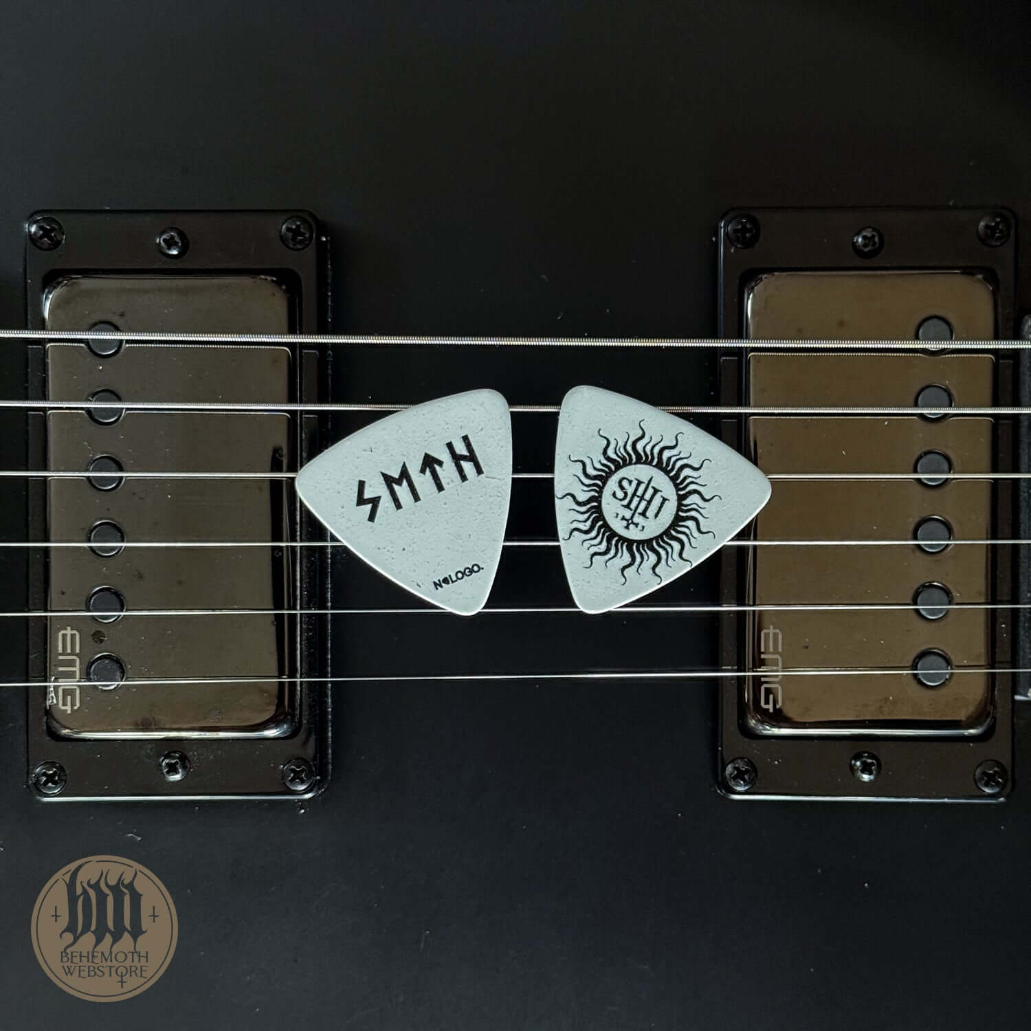 White plastic guitar picks on electric guitar strings featuring Seth signature and 'TSOG' print, 0.88 mm thickness, single item sale.