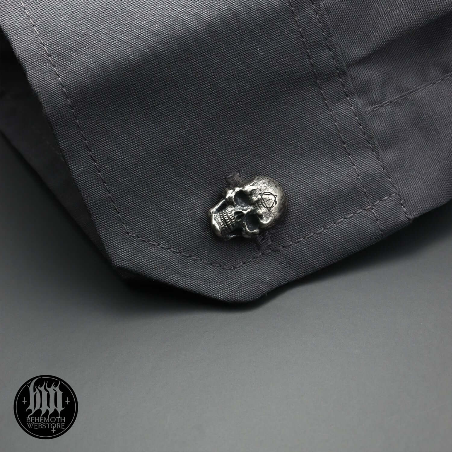 Alt Tag: Sterling silver skull cufflink on dark shirt sleeve, handcrafted with intricate details, made by Anna Mazon Jewellery.