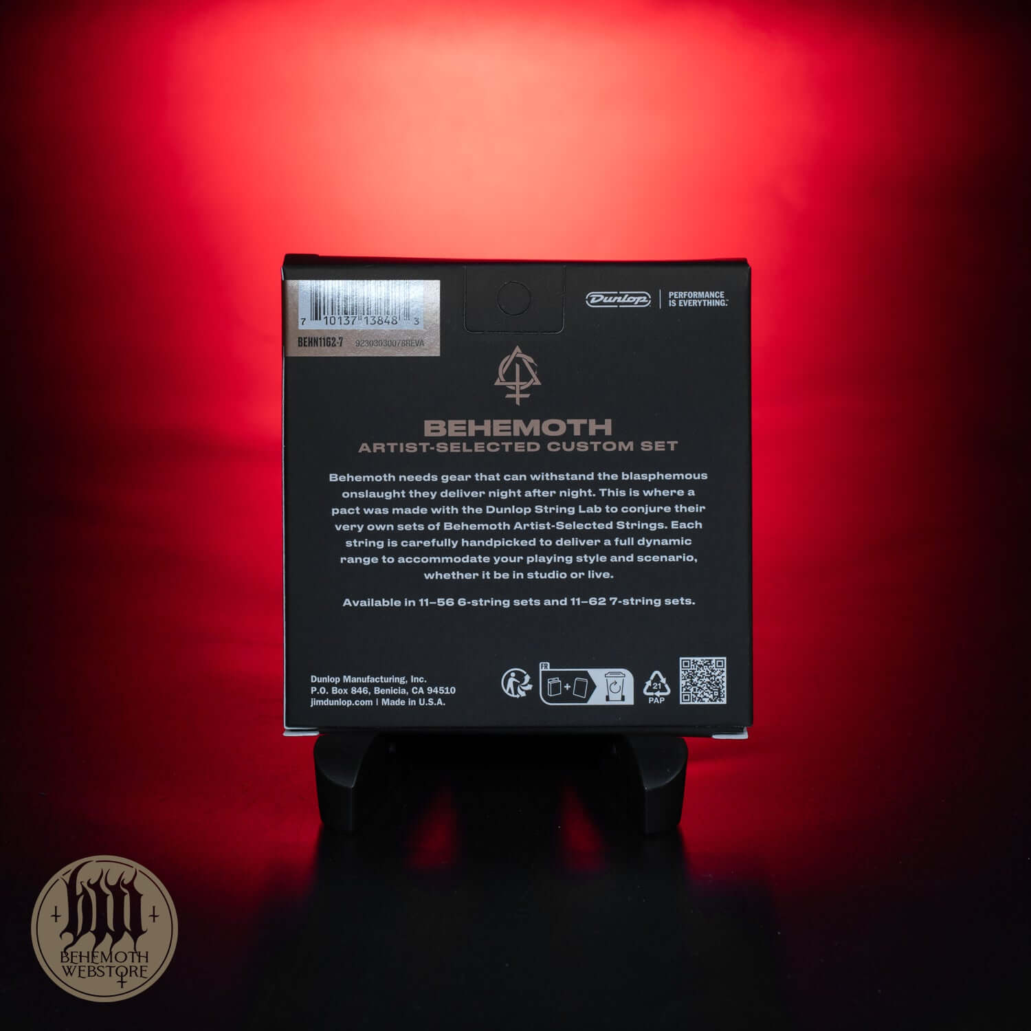 Back view of Behemoth Dunlop Artist-Selected 7 String Electric Guitar Strings 11-62 packaging on a red background.