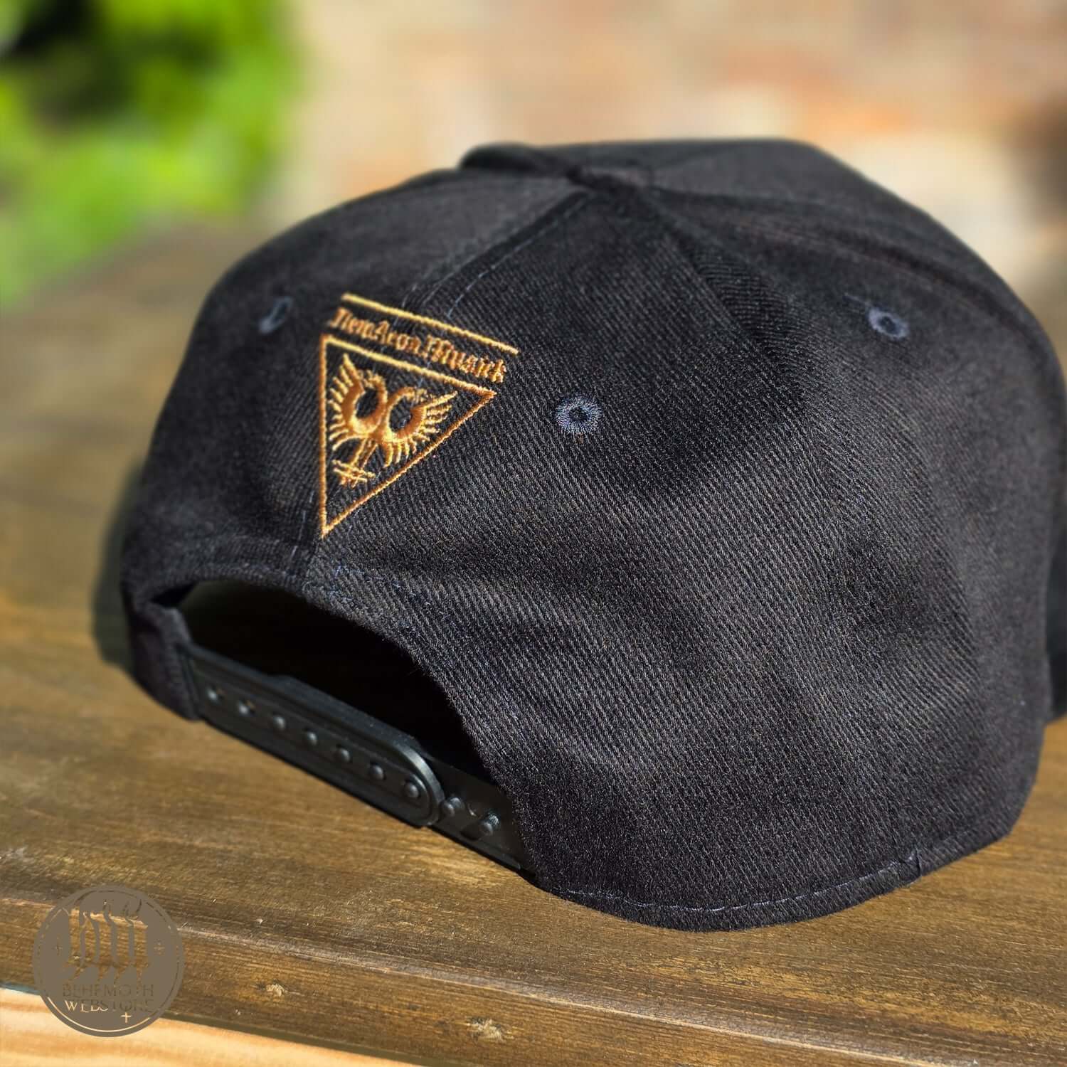 Back view of Behemoth 'Trivmviratvs' snapback cap with New Aeon Musick logo, adjustable strap, and high-quality Polish craftsmanship.