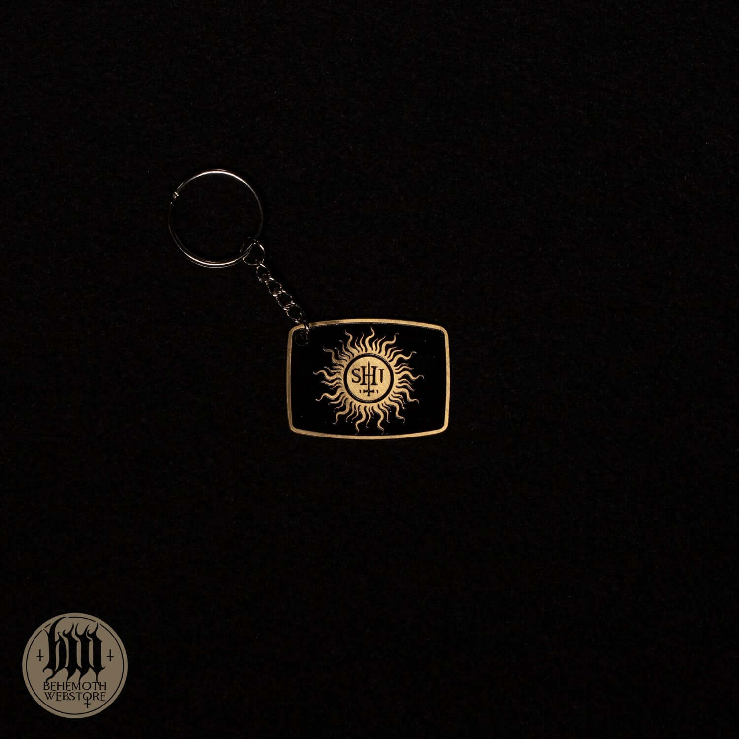 Behemoth 'TSOG' brass keychain with patina cover, featuring a sun design, size 4 x 3.2 cm. High-quality accessory.