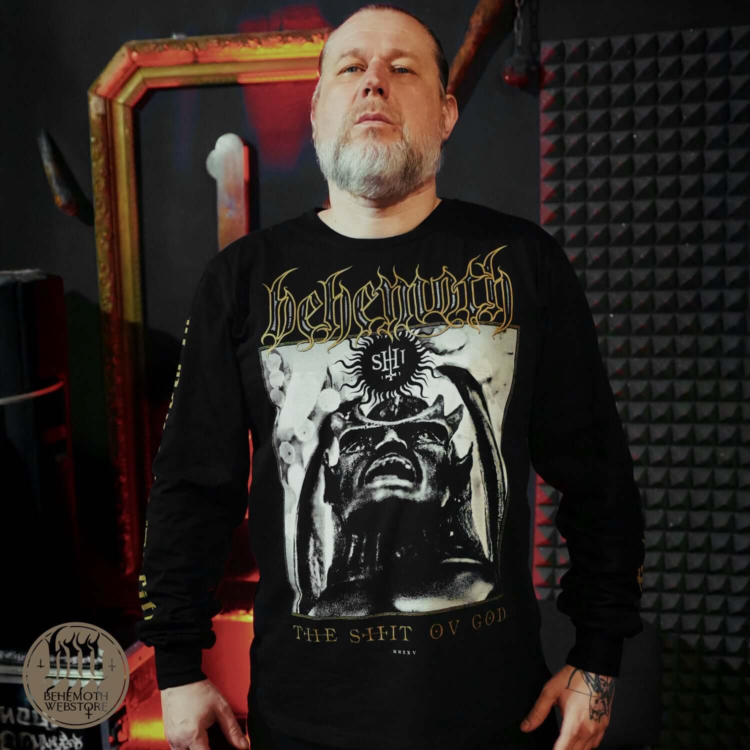 Model wearing Behemoth 'The Shit Ov God' long sleeve shirt with sigil graphics, made from premium cotton. Iconic metal band merchandise.